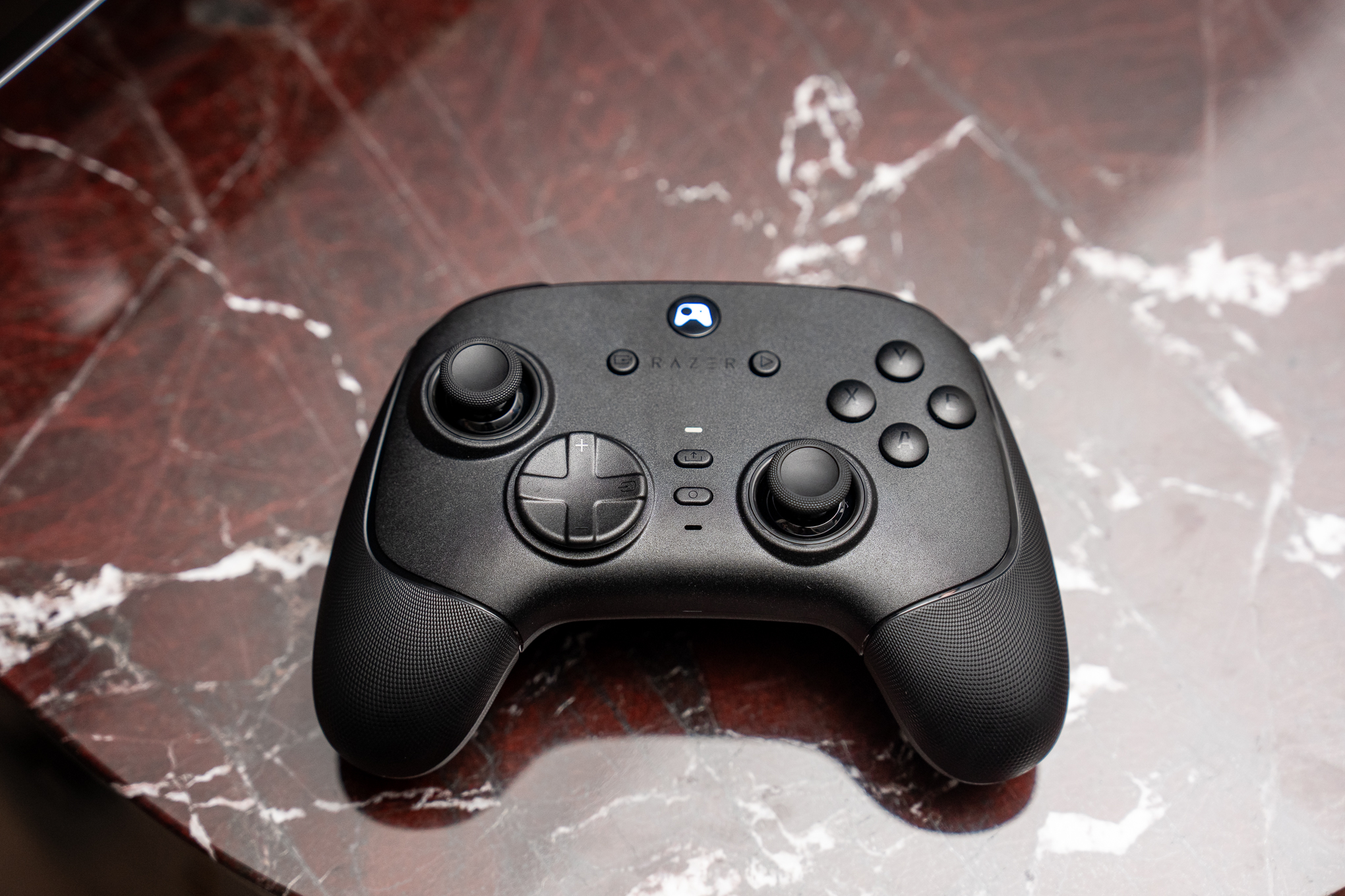 A Razer Wolverine V3 BT controller on a marble surface.