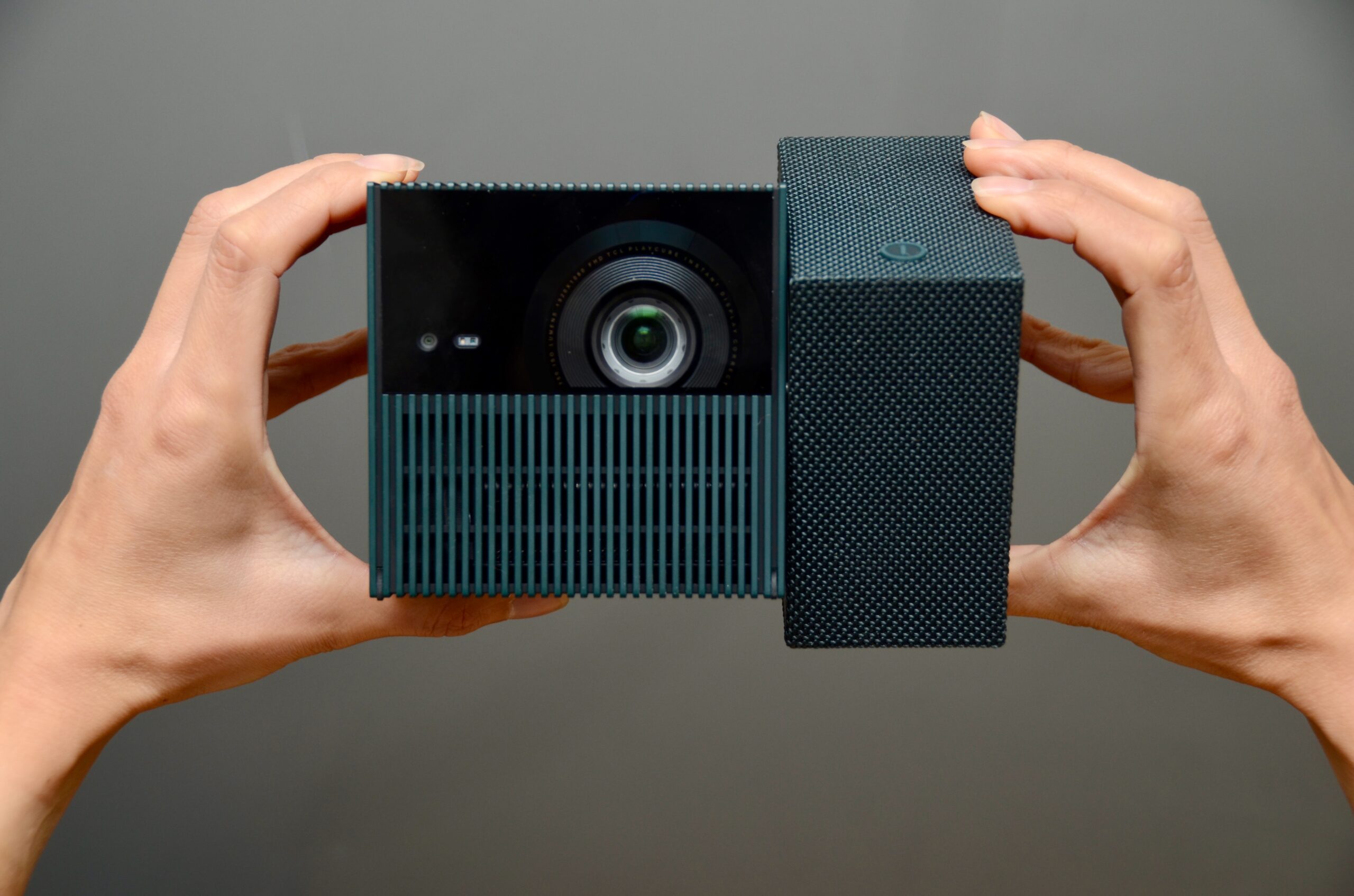 The PlayCube being twisted when held between two hands.