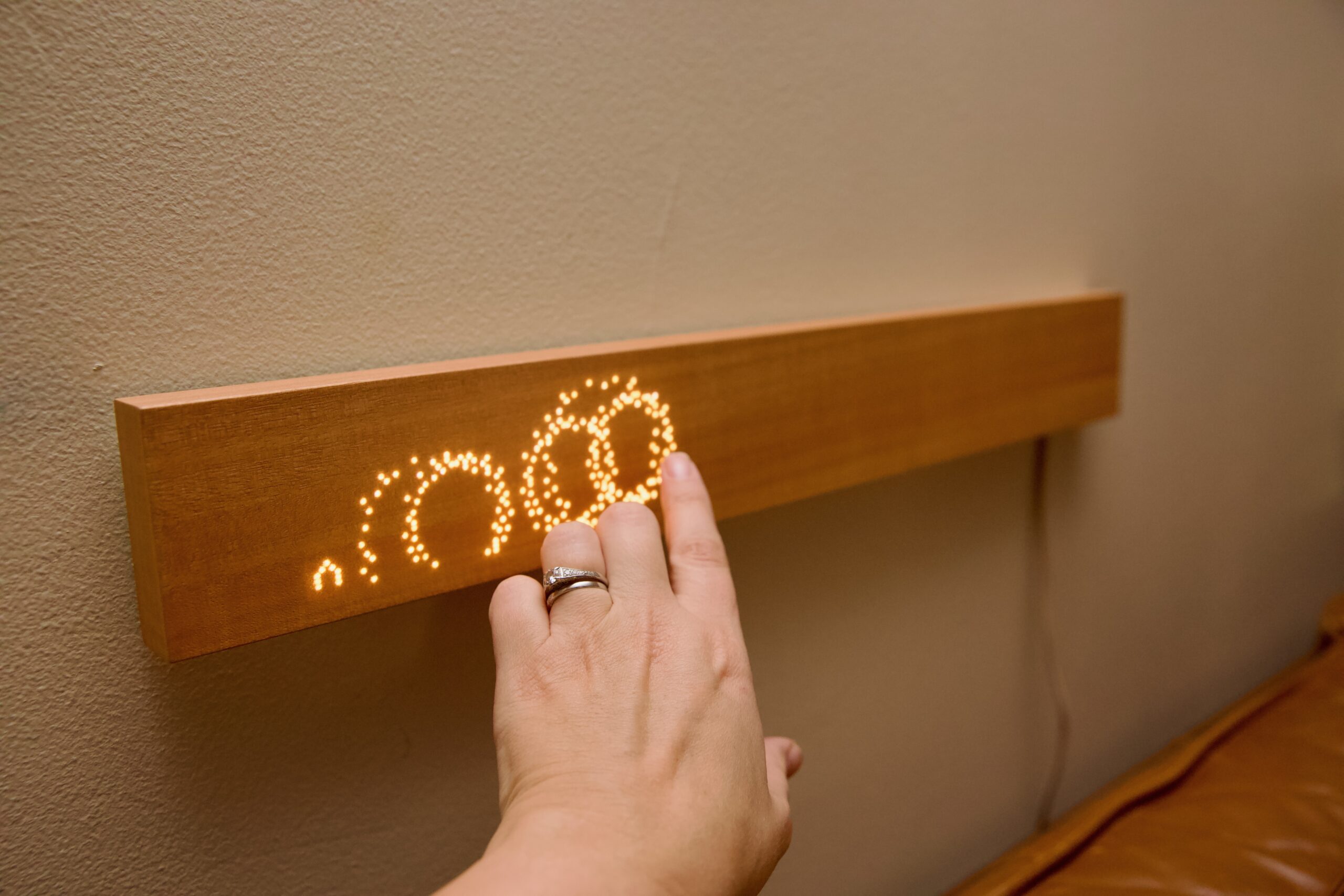 A hand drawing on a wooden board mounted to a wall.