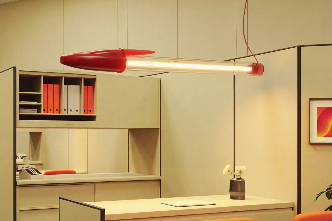 The Seletti Bic Lamp hanging from a ceiling over an office desk.
