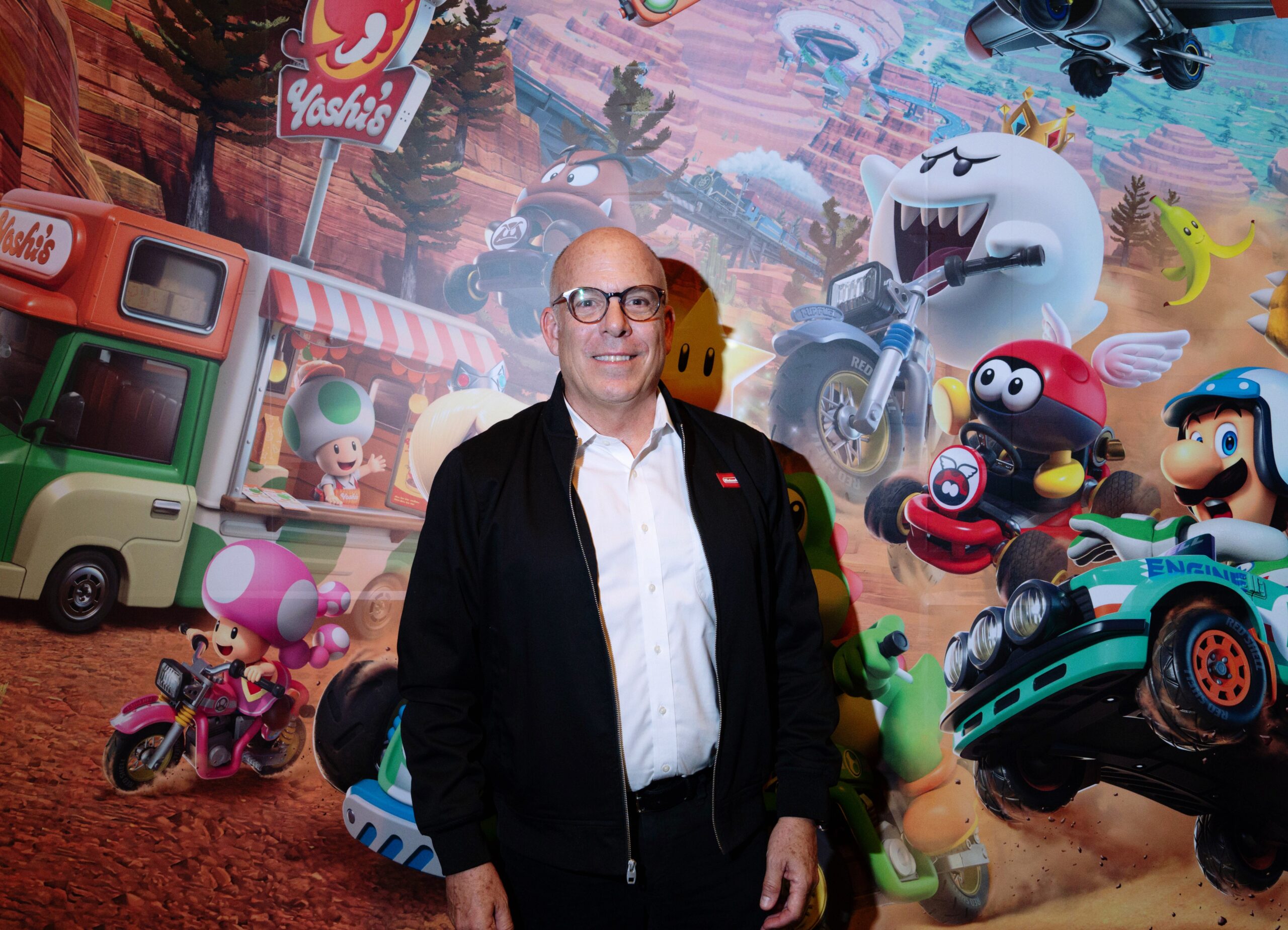 A photo of Doug Bowser in front of a Nintendo-themed backdrop