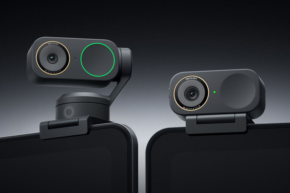 A close-up of the Insta360 Link 2 Pro and Link 2C Pro webcams sitting on top of laptop screens.