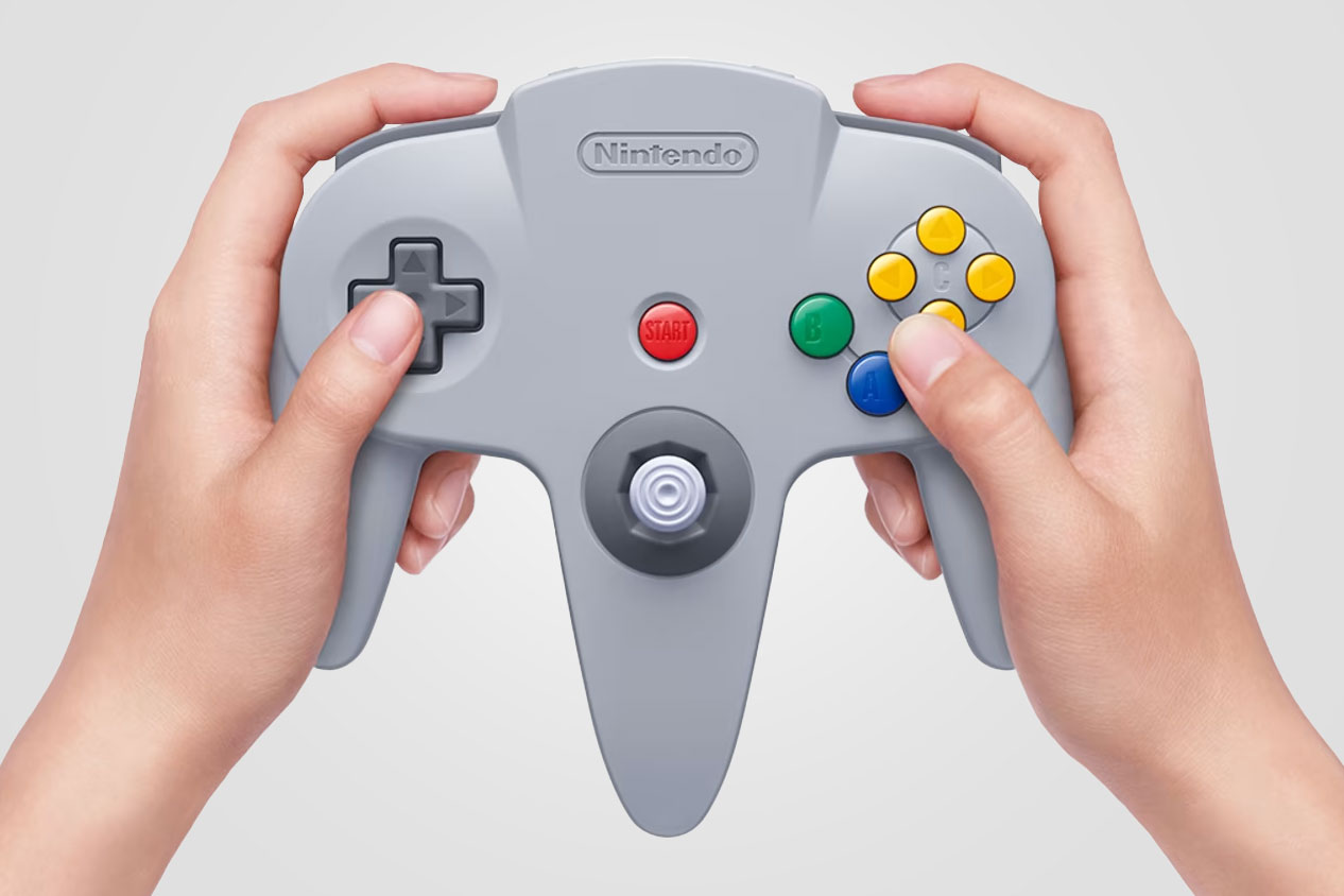 A person holding Nintendo’s wireless recreation of the N64 controller.