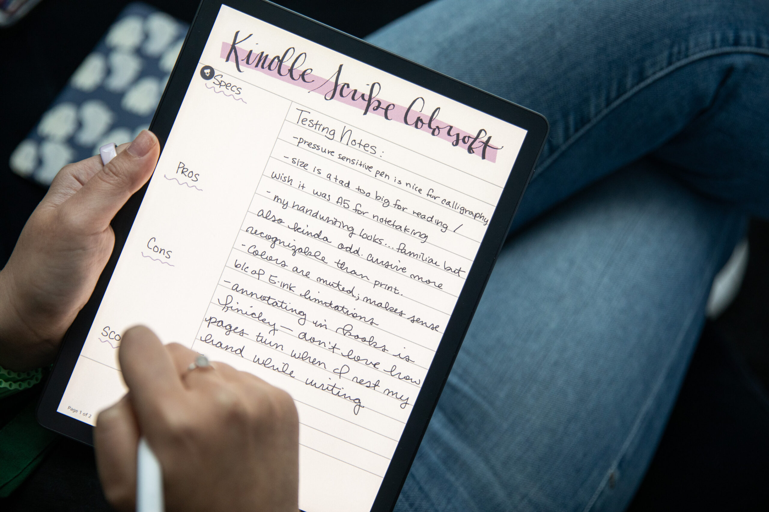 A person writing on the Kindle Scribe Colorsoft with a stylus.