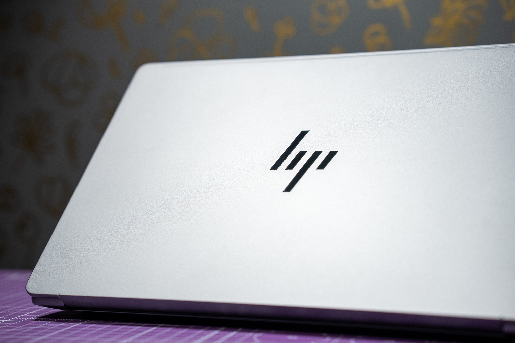 A close-up of an HP logo on a laptop lid.