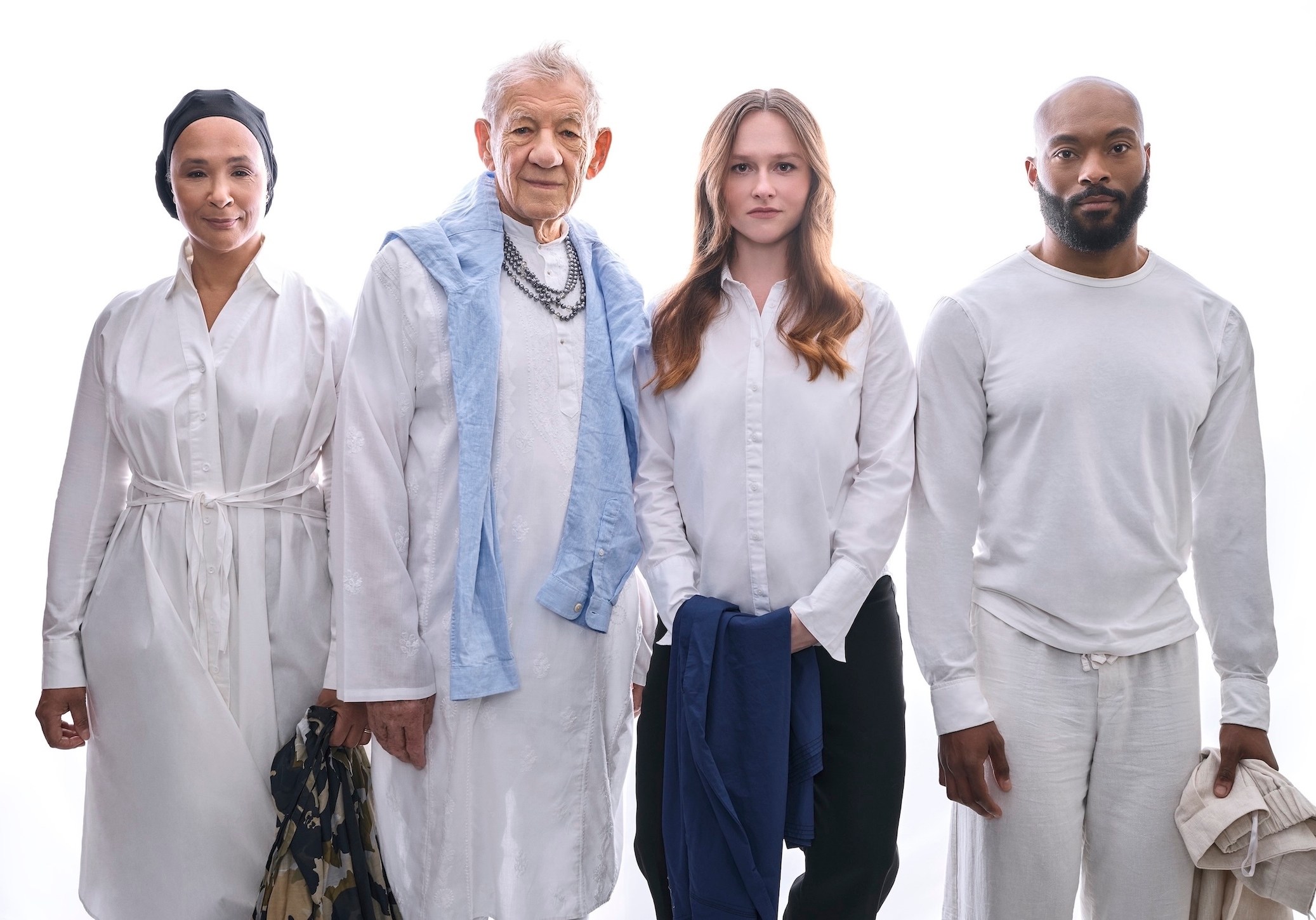 Two men and two women standing shoulder to shoulder in a white voice.