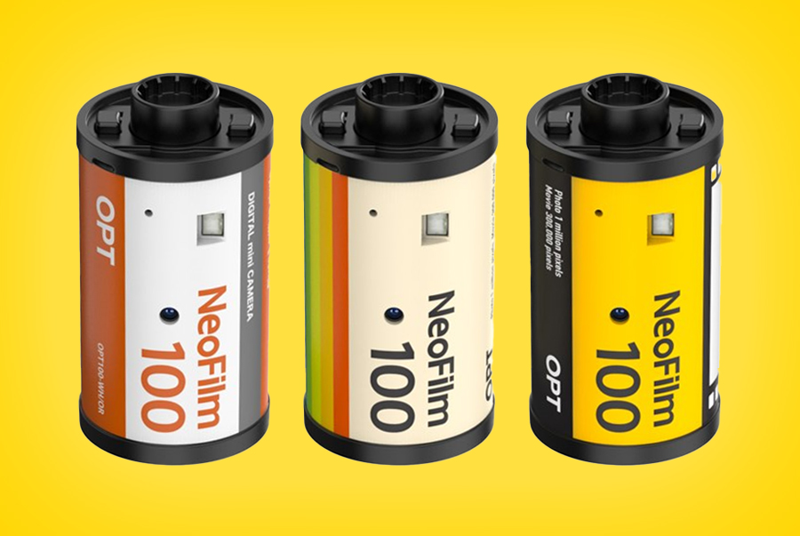 Three of the OPT100 digital cameras against a yellow background.