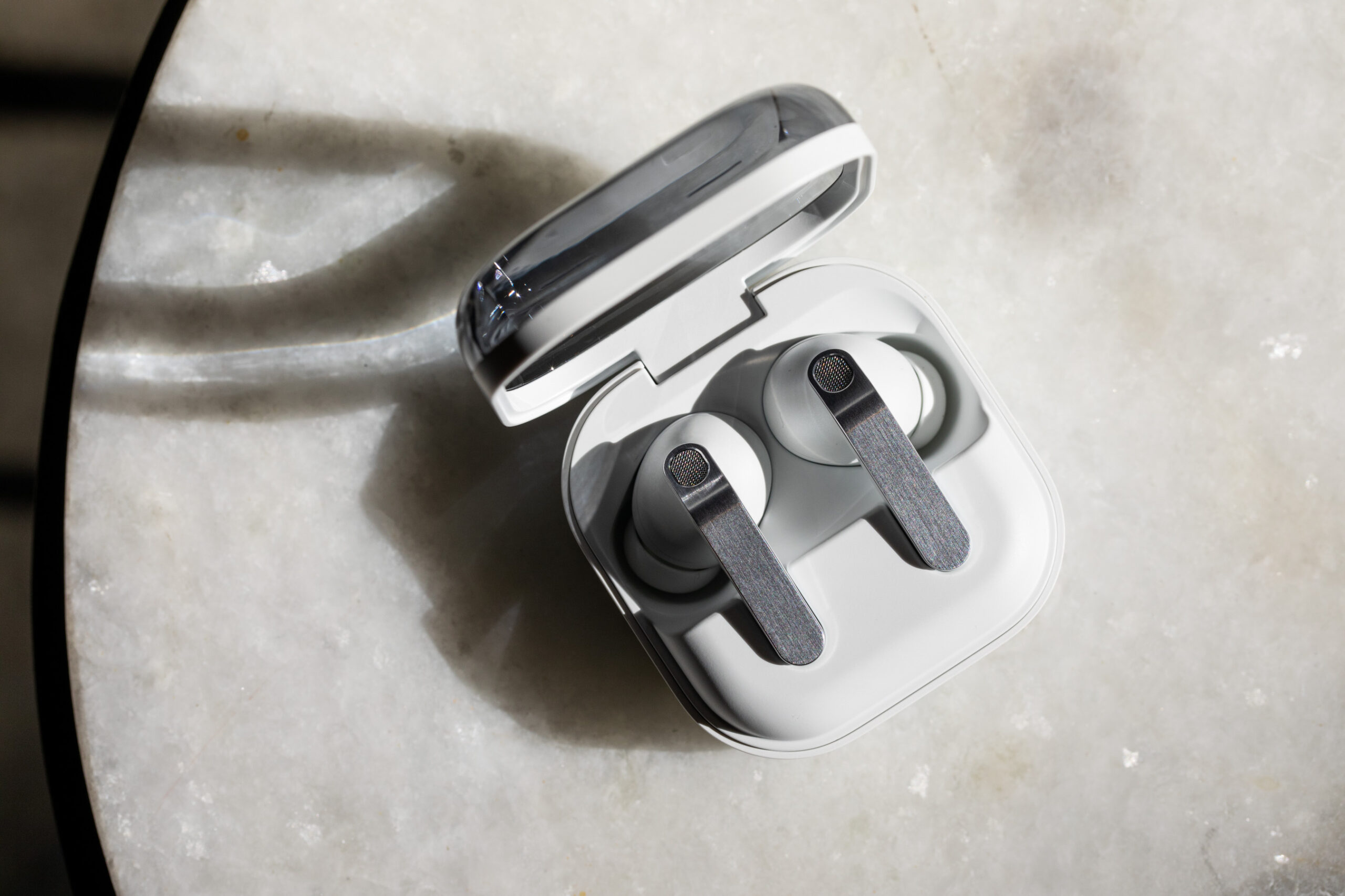 The Samsung Galaxy Buds 4 Pro in their open charging case on a white tabletop.