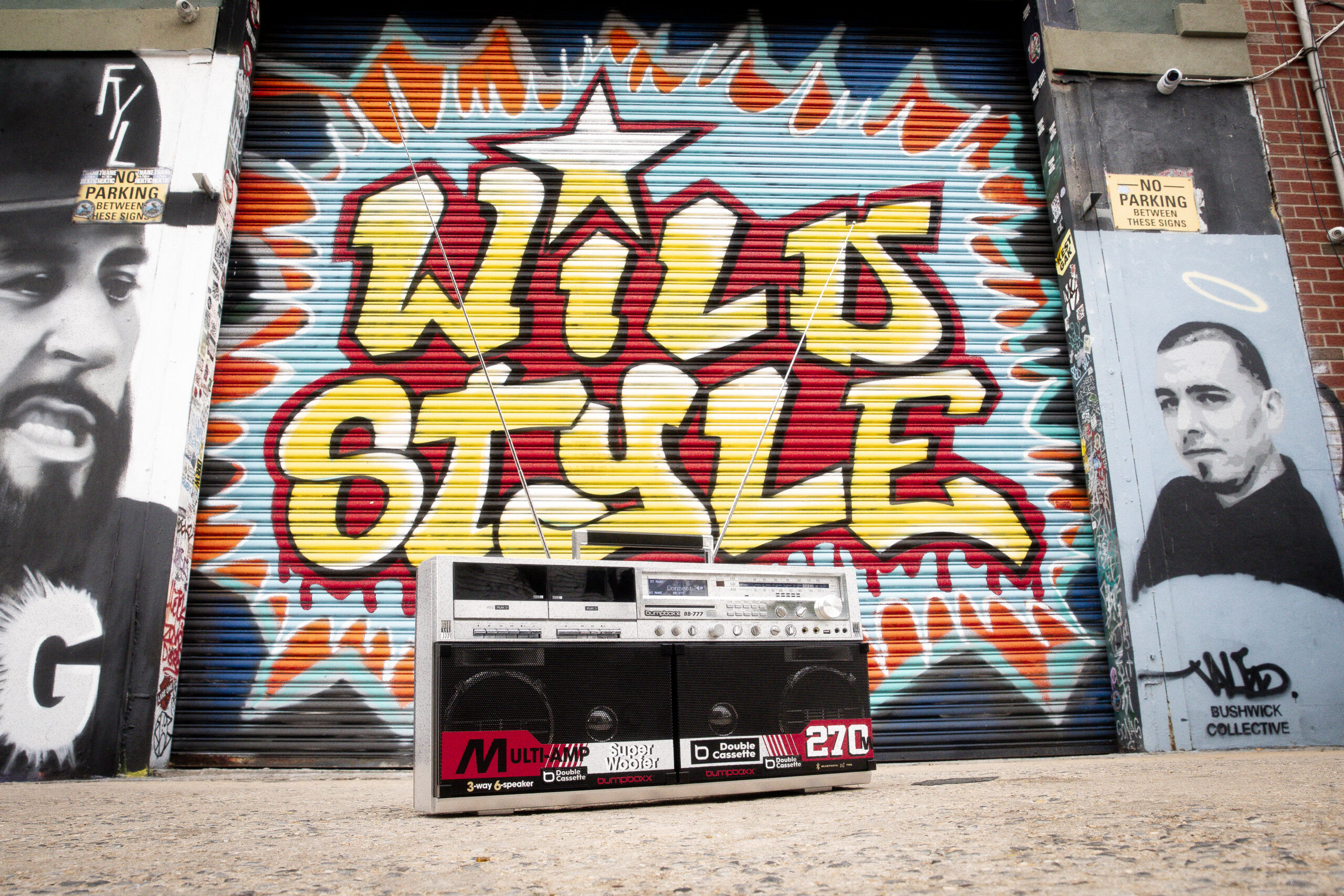 BB-777 boombox on the sidewalk in front of a Wild Style mural.