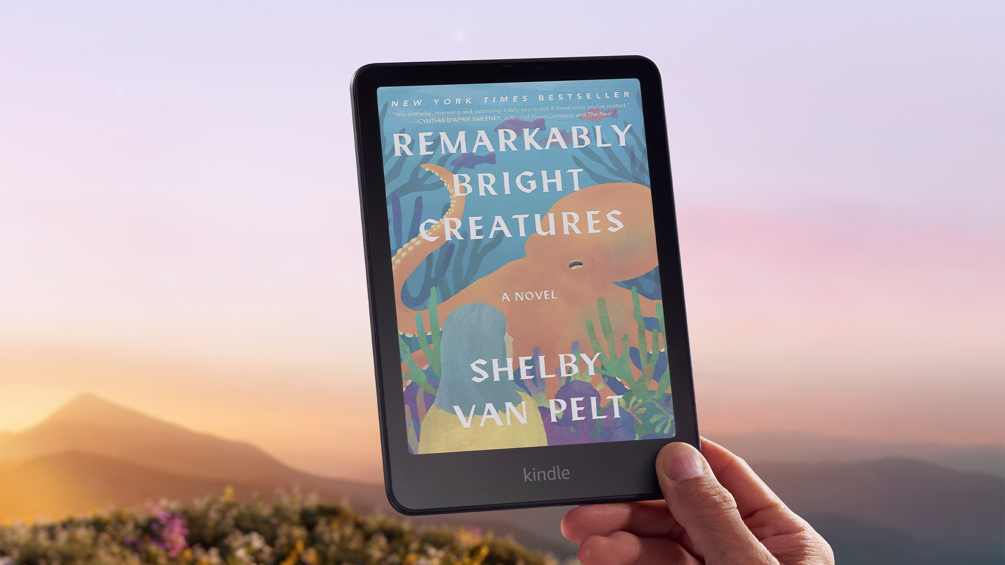 A photo of a person holding a Kindle Colorsoft e-reader.