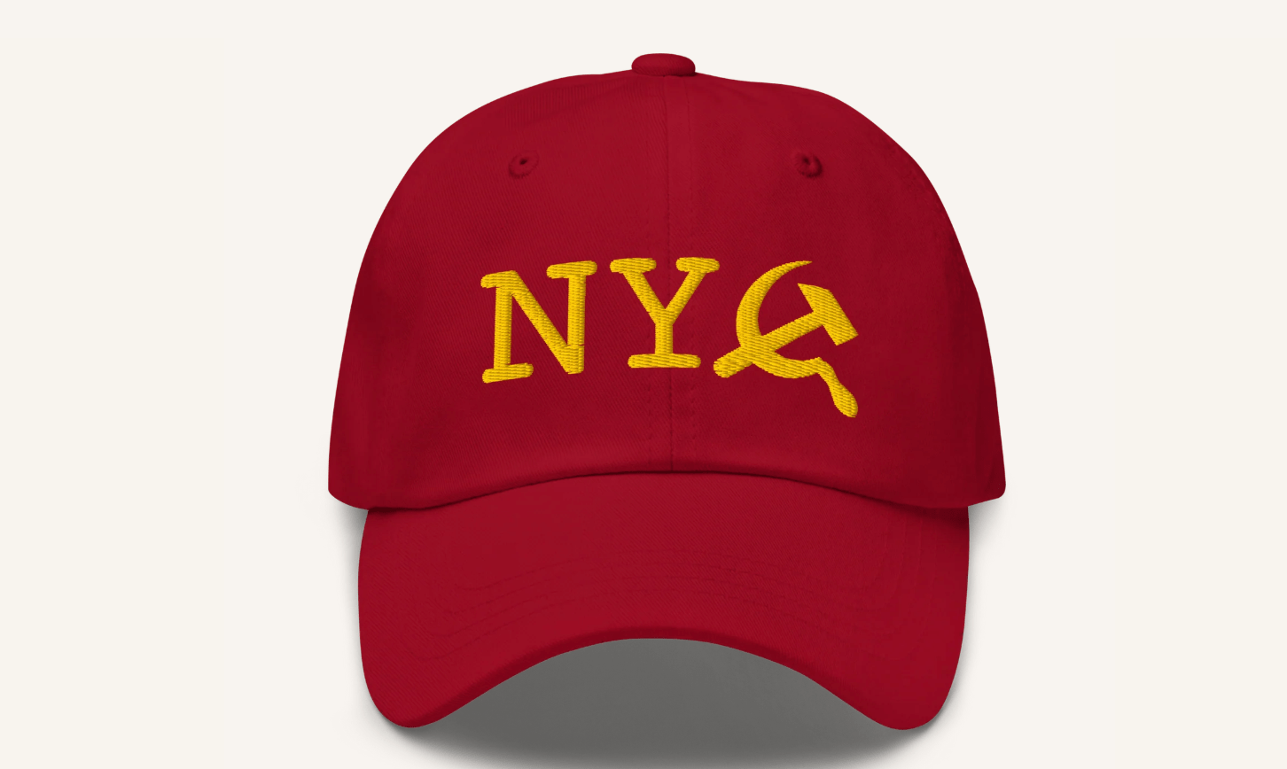 Red baseball hat with NYC embroidery, except the C is the hammer and sickle symbol