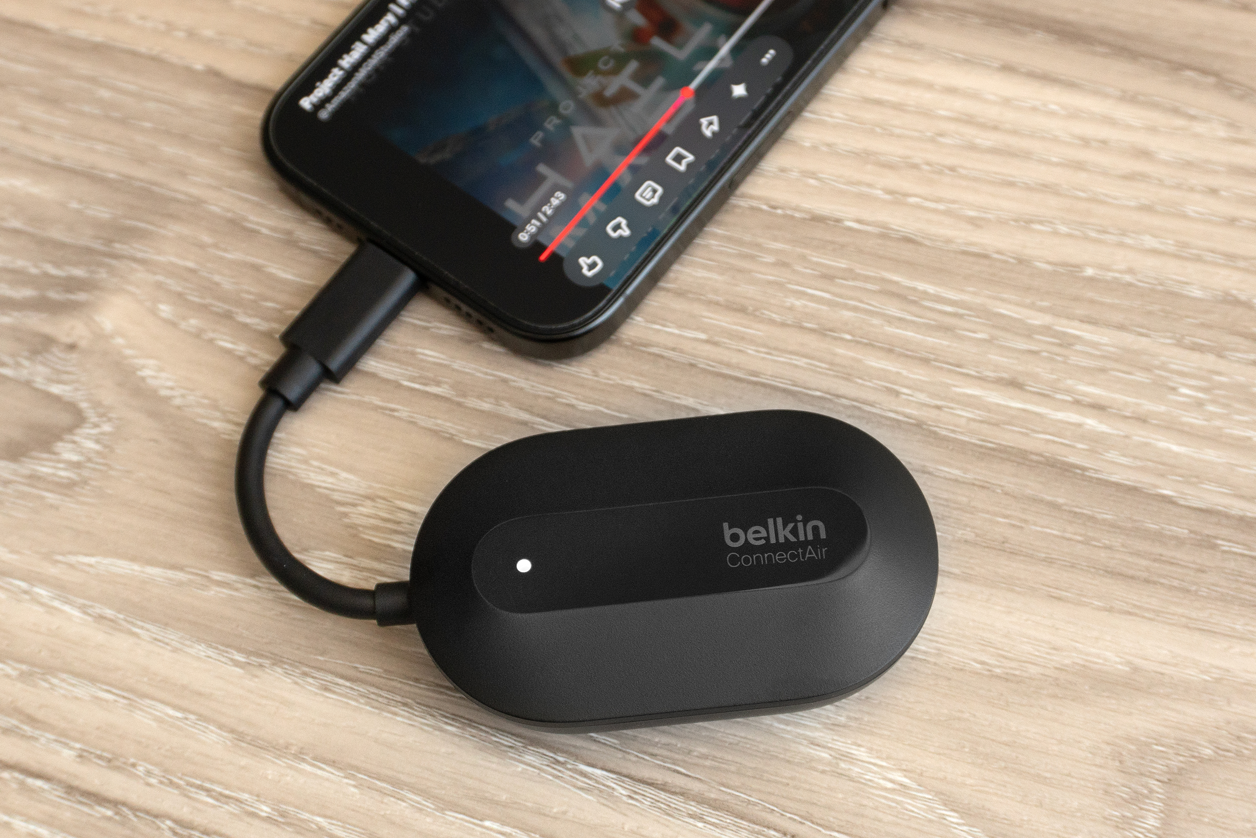 The Belkin ConnectAir wireless HDMI dongle connected to an iPhone.