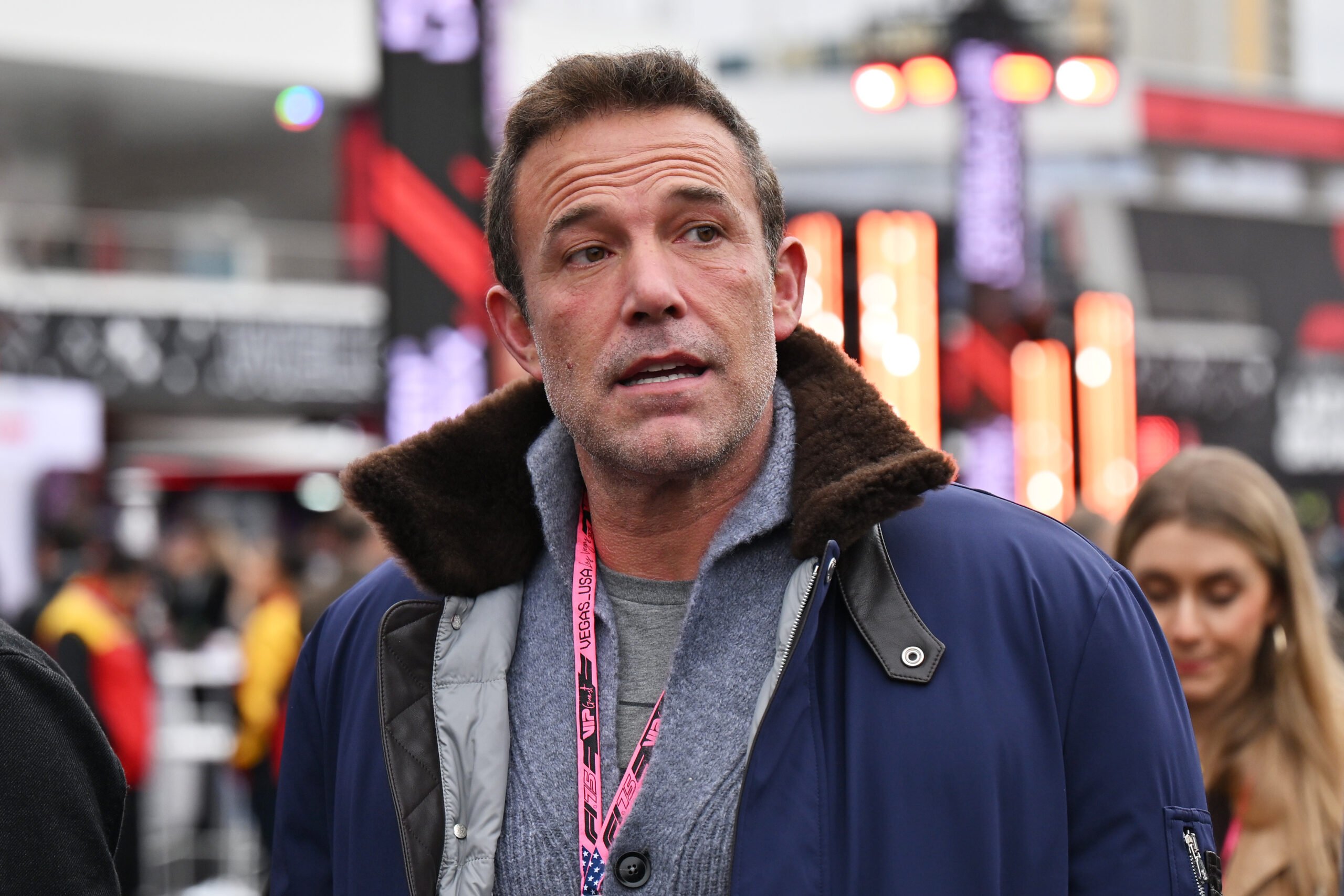 Actor Ben Affleck wearing a coat over a quarter zip.