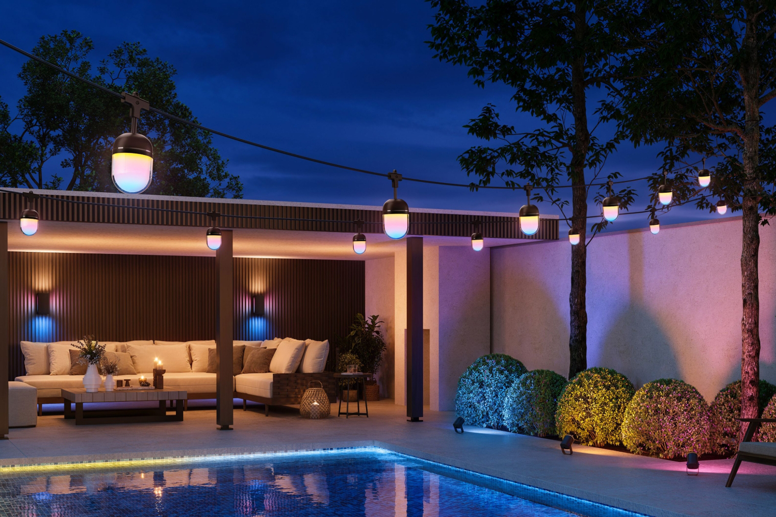 Govee’s Outdoor Chromatic String Lights hanging over a backyard with a pool in the evening.