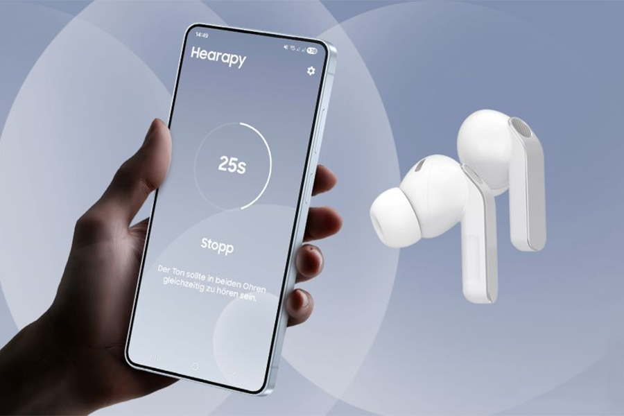 A hand holding a phone running the Samsung Hearapy app with a pair of wireless earbuds floating next to it.