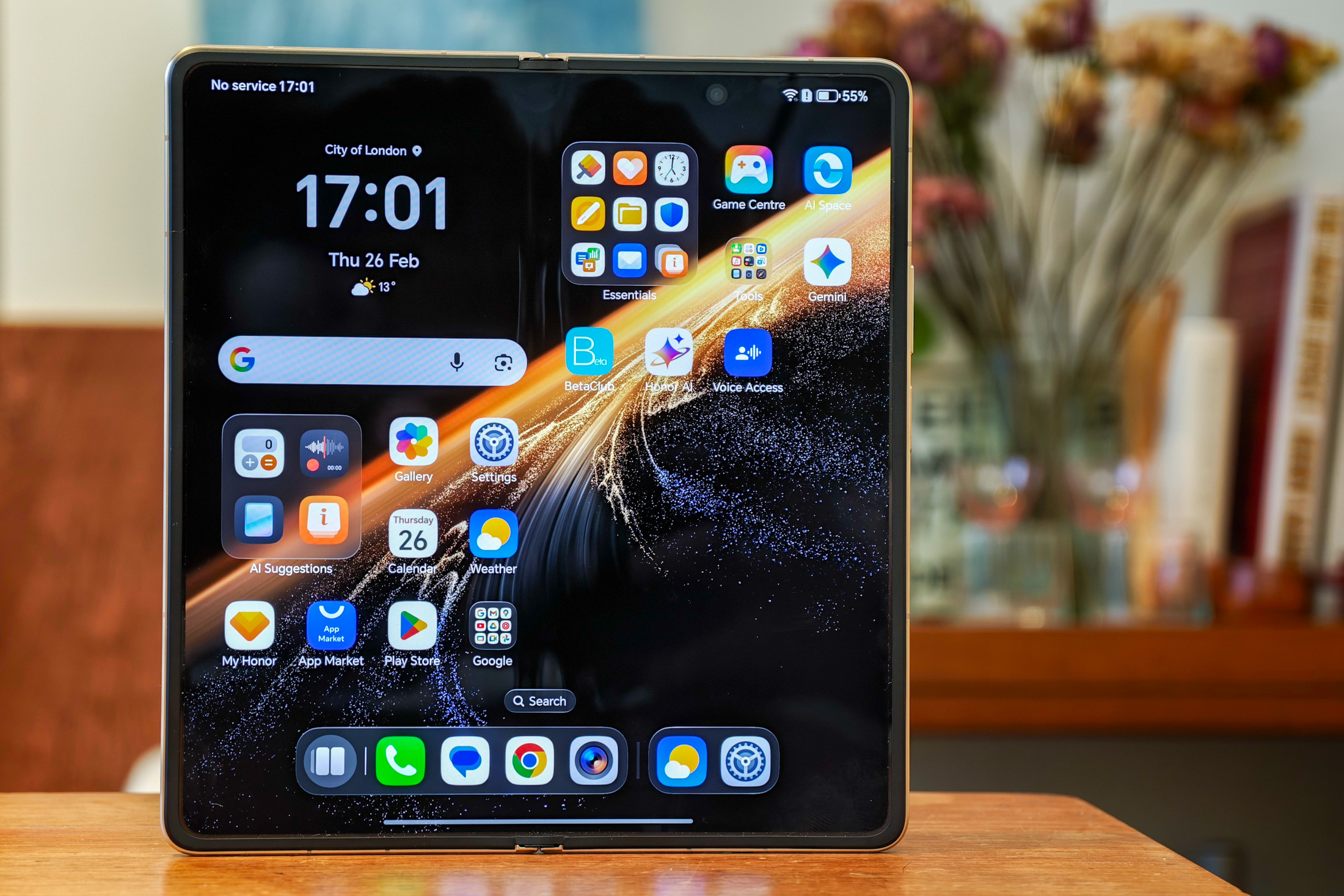 Photo of the Honor Magic V6, open, on a wooden table