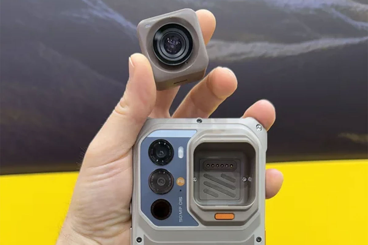 A person holds the RugOne Xsnap 7 Pro phone with its camera module removed.