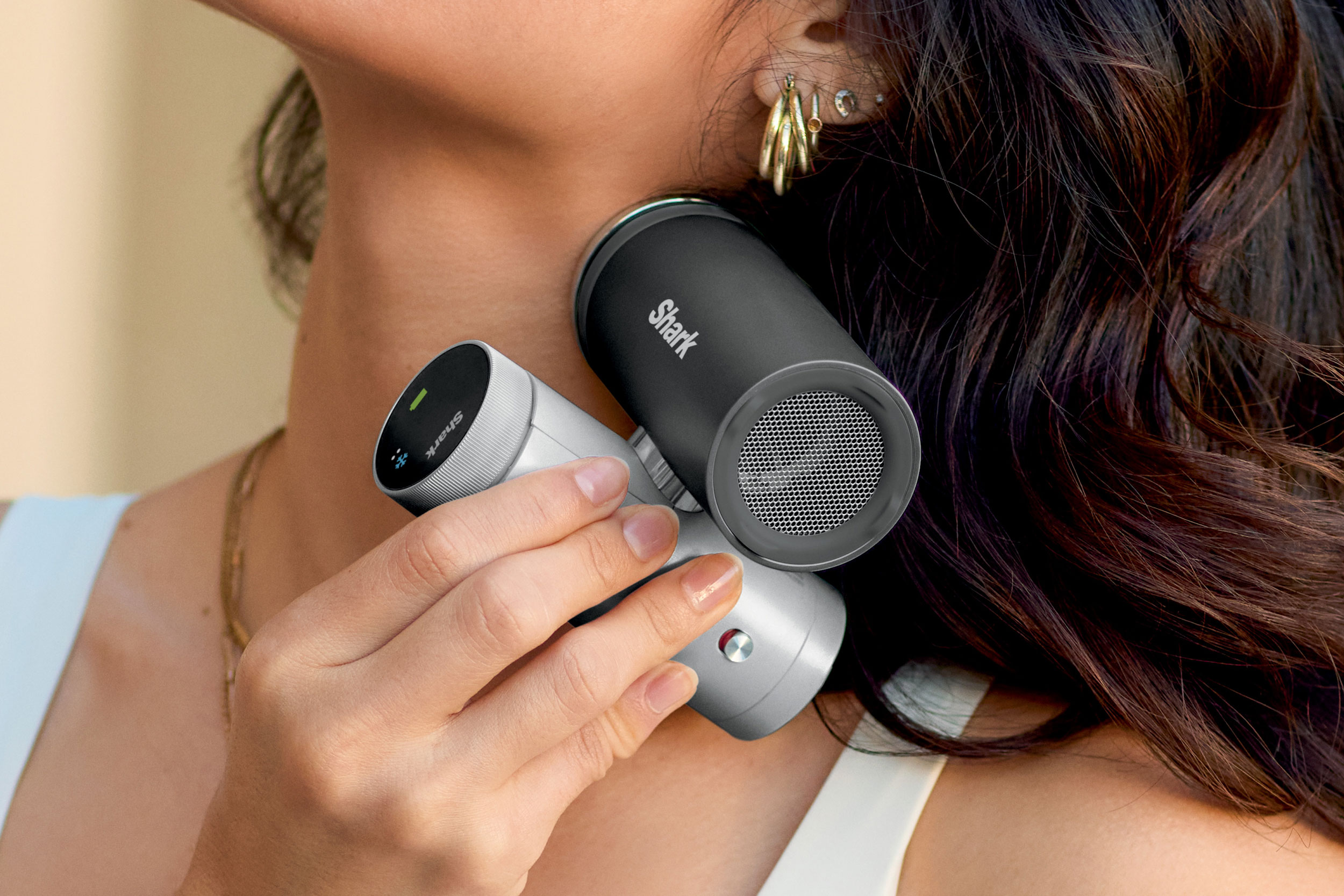 A person holds the Shark ChillPill against their neck.