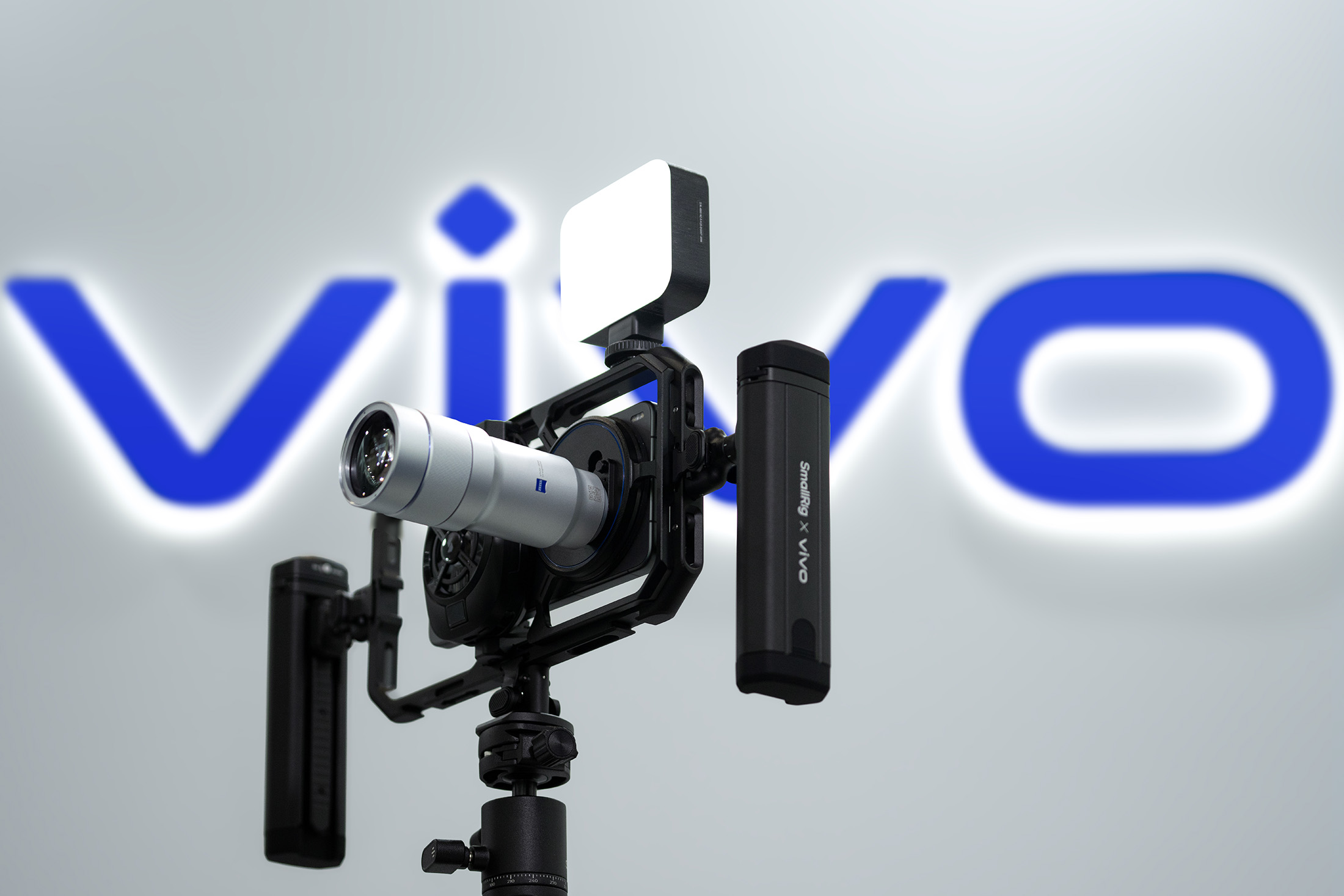 Product render of Vivo X300 Ultra with 400mm telephoto extender lens attached and mounted in a camera cage