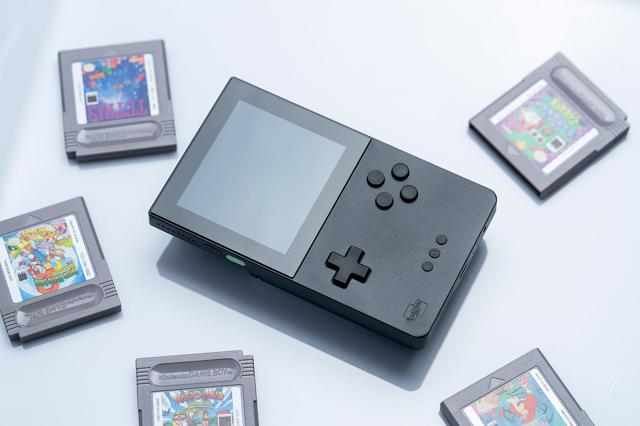 An Analogue Pocket surrounded by game cartridges.