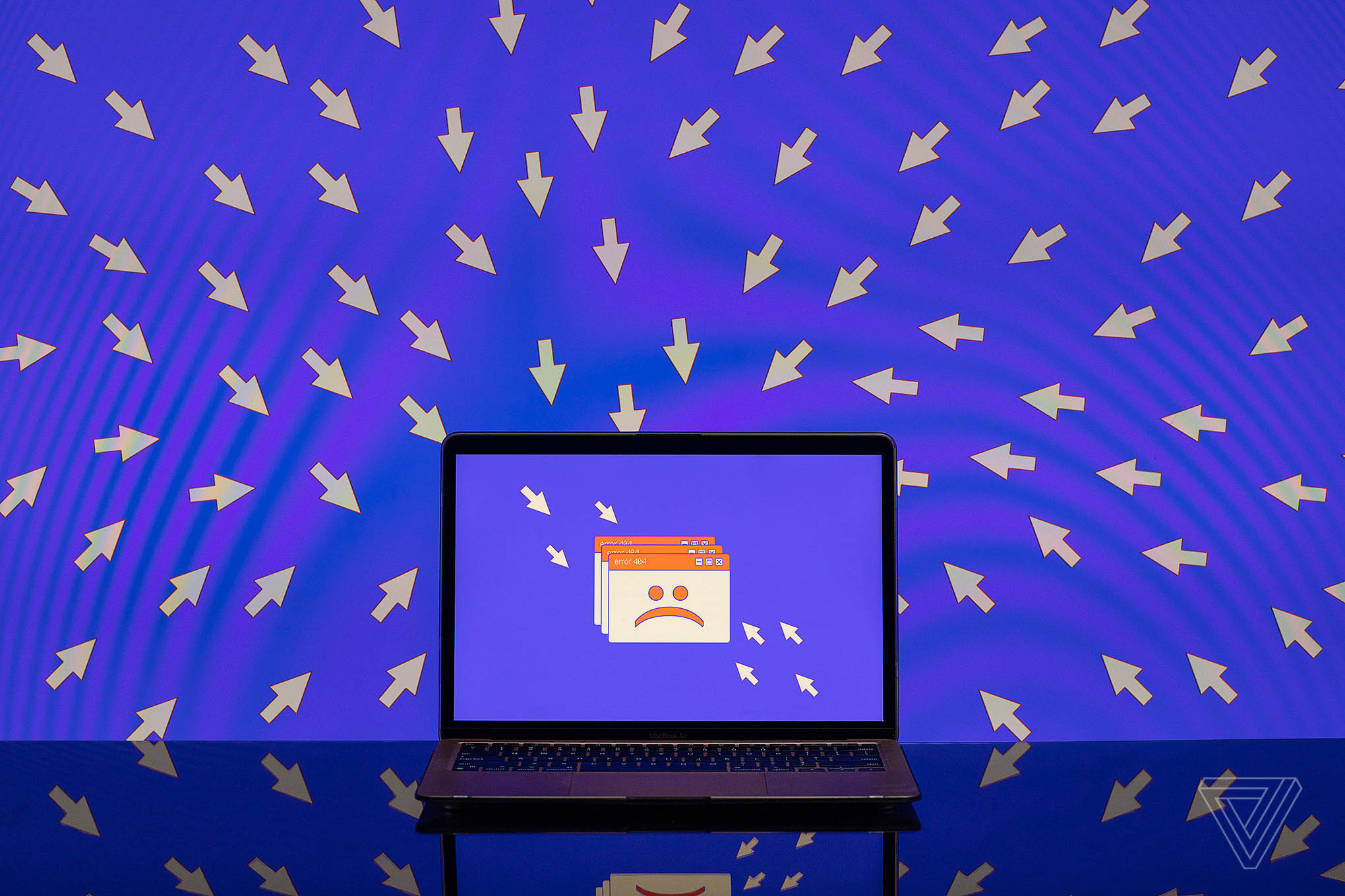 A number of cursors point toward an unhappy face on a laptop