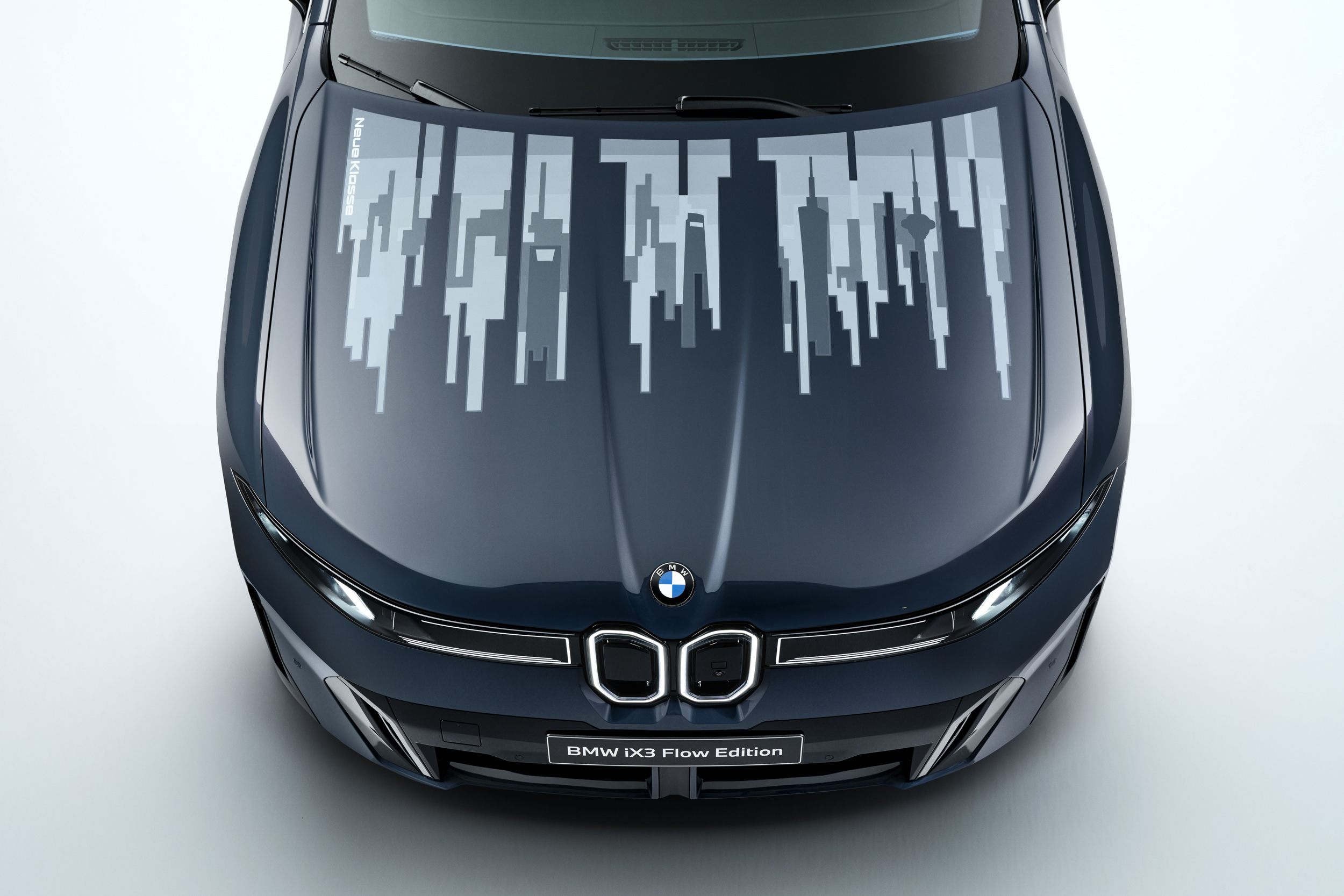 An overhead look at the hood on the BMW iX3 Flow Edition concept car showing an animated design.
