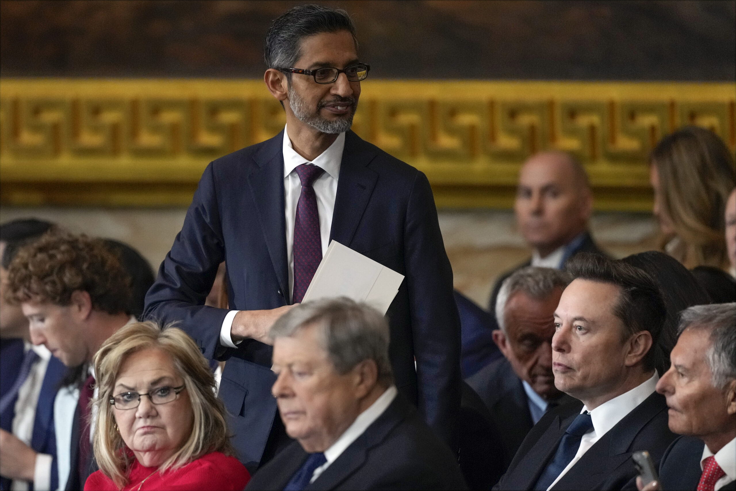 Sundar Pichai standing among seated attendees at the inauguration