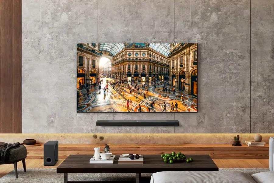 An LG B5 OLED TV hanging on the wall in a living room with a soundbar underneath it.