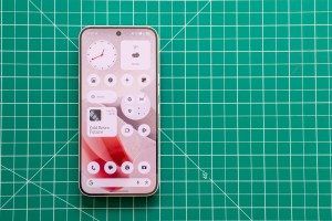 Photo of Nothing Phone 4A Pro on a green cutting mat showing the homescreen