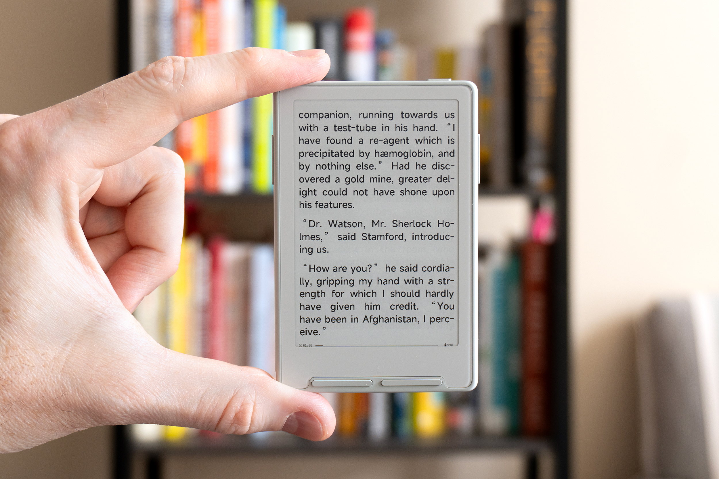 A person holds the Xteink X3 e-reader between two fingers. A person holds the Xteink X3 e-reader between two fingers.