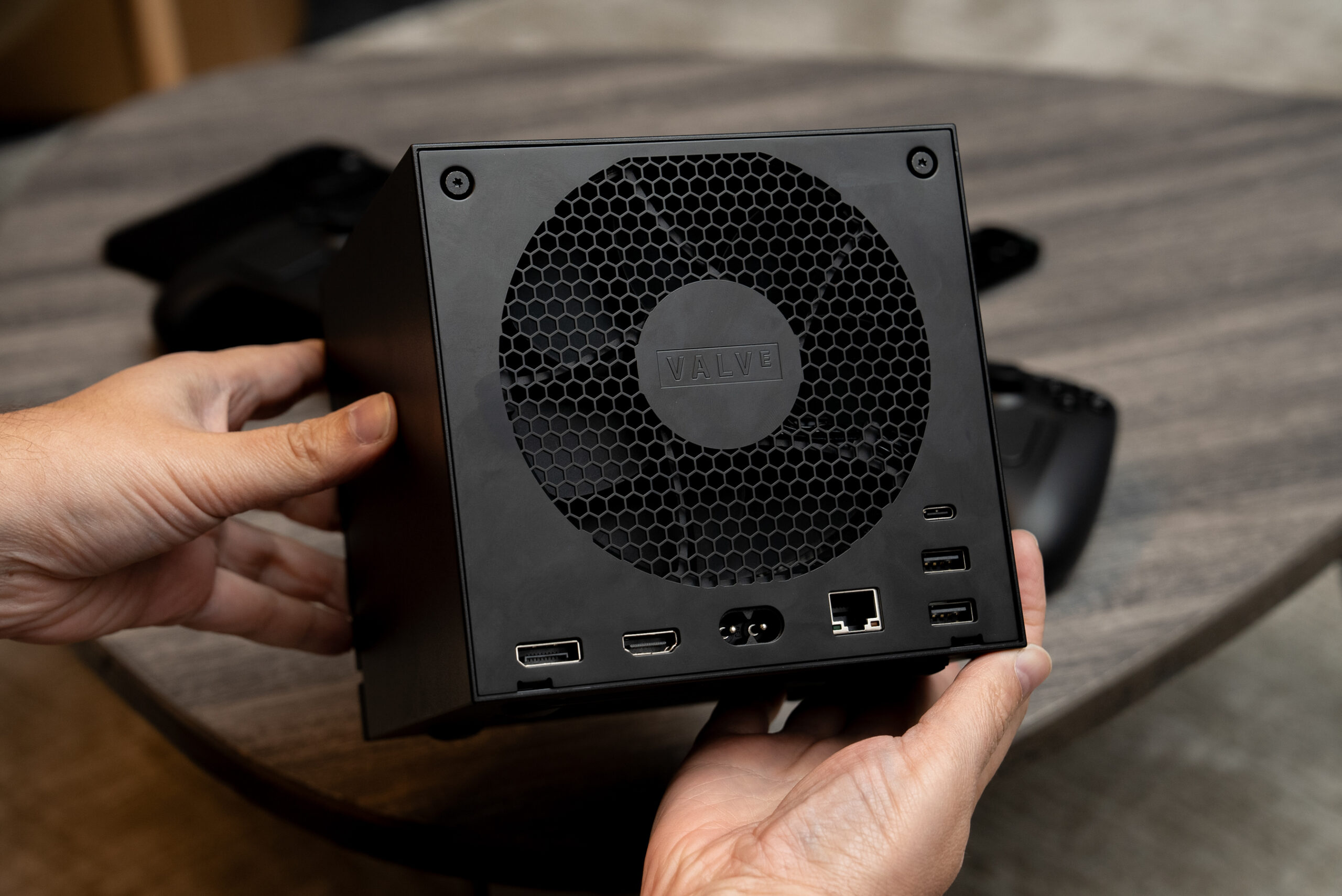 The Steam Machine’s rear, showing how a 120mm fan takes up almost the entirety, but surrounded by ports including USB-A, C, Ethernet, HDMI, and DisplayPort.