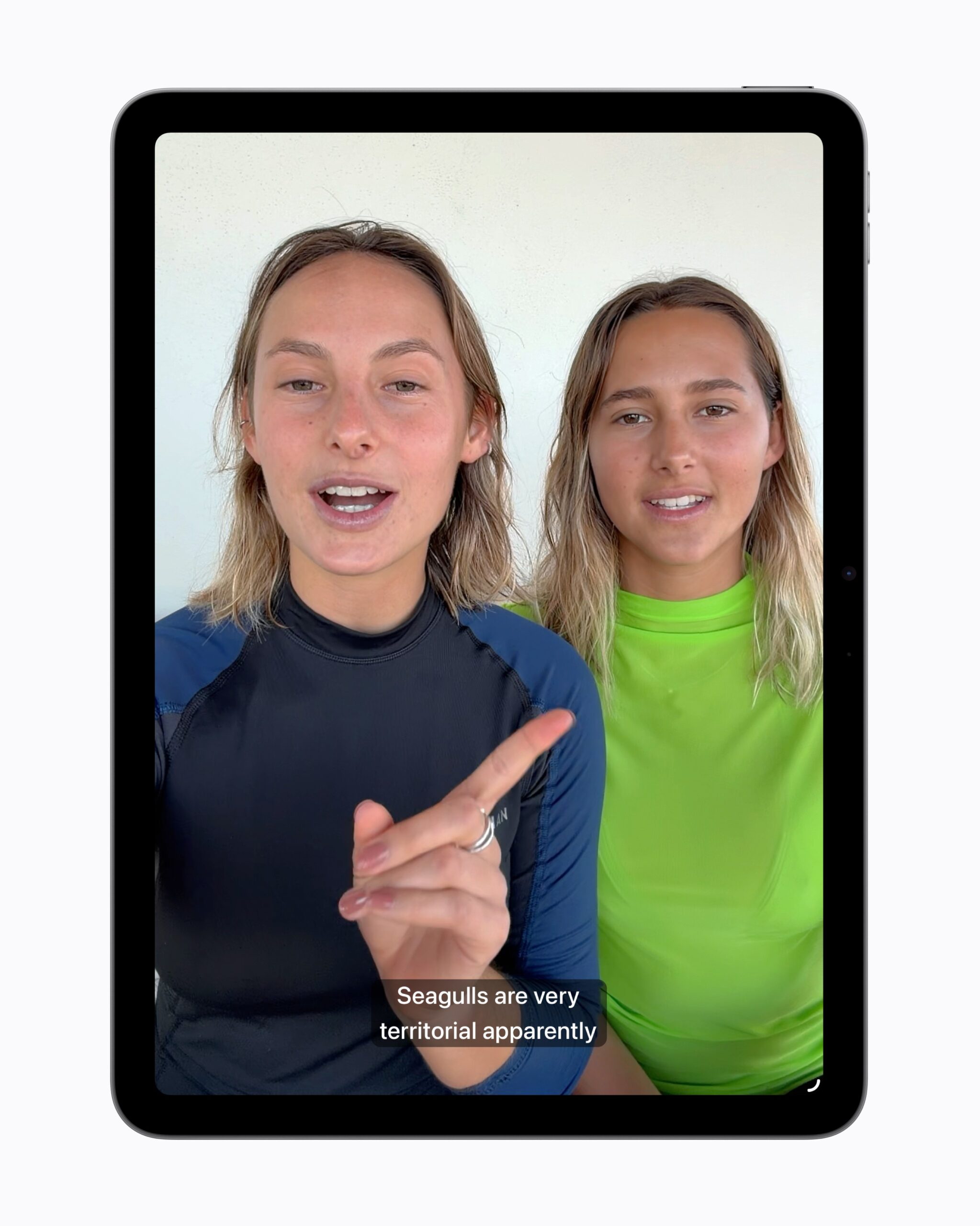 iPad shown playing a video with AI-generated subtitles