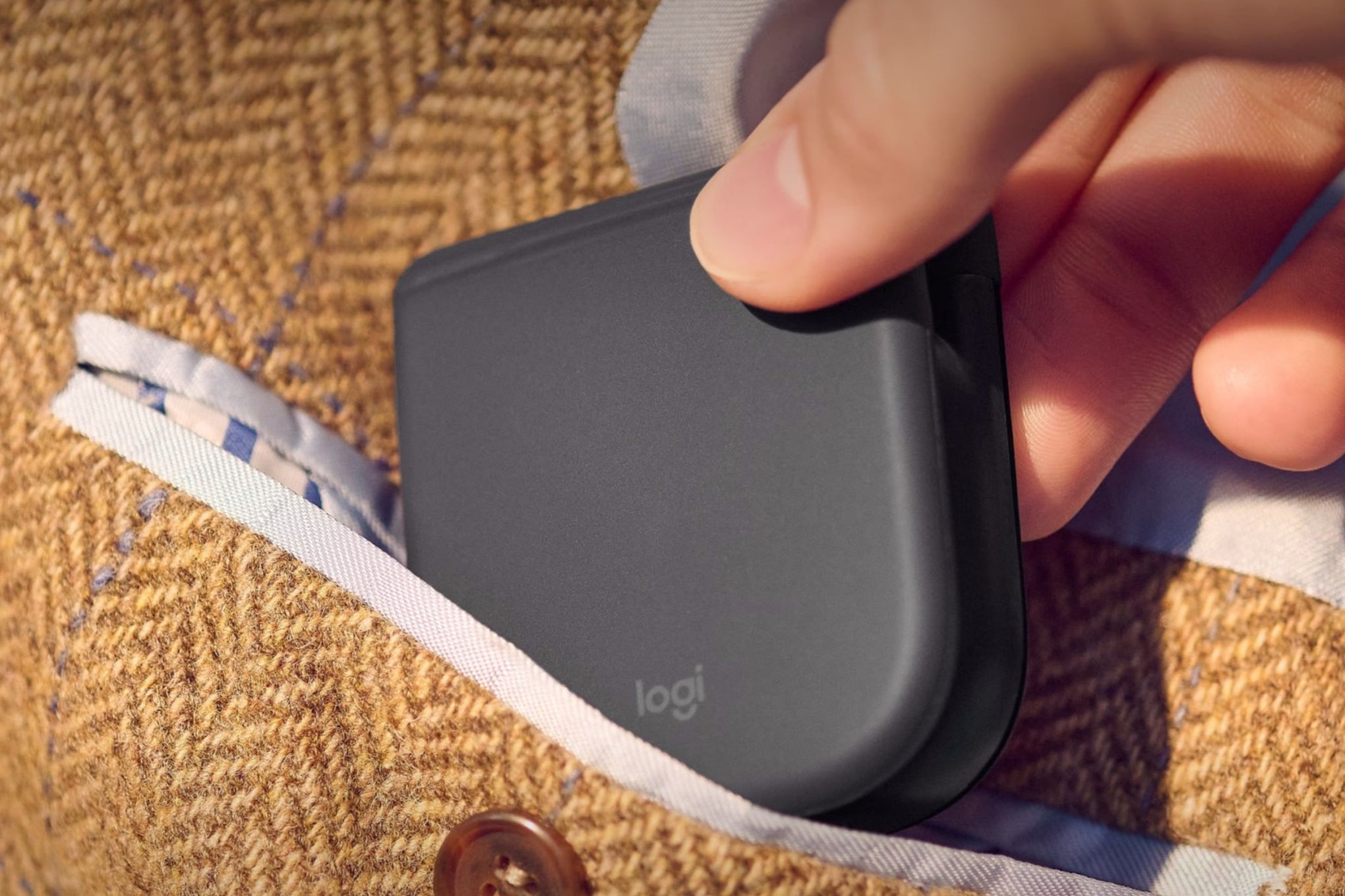 A leaked image of an unnamed folding Logitech mouse, being placed into a pocket.
