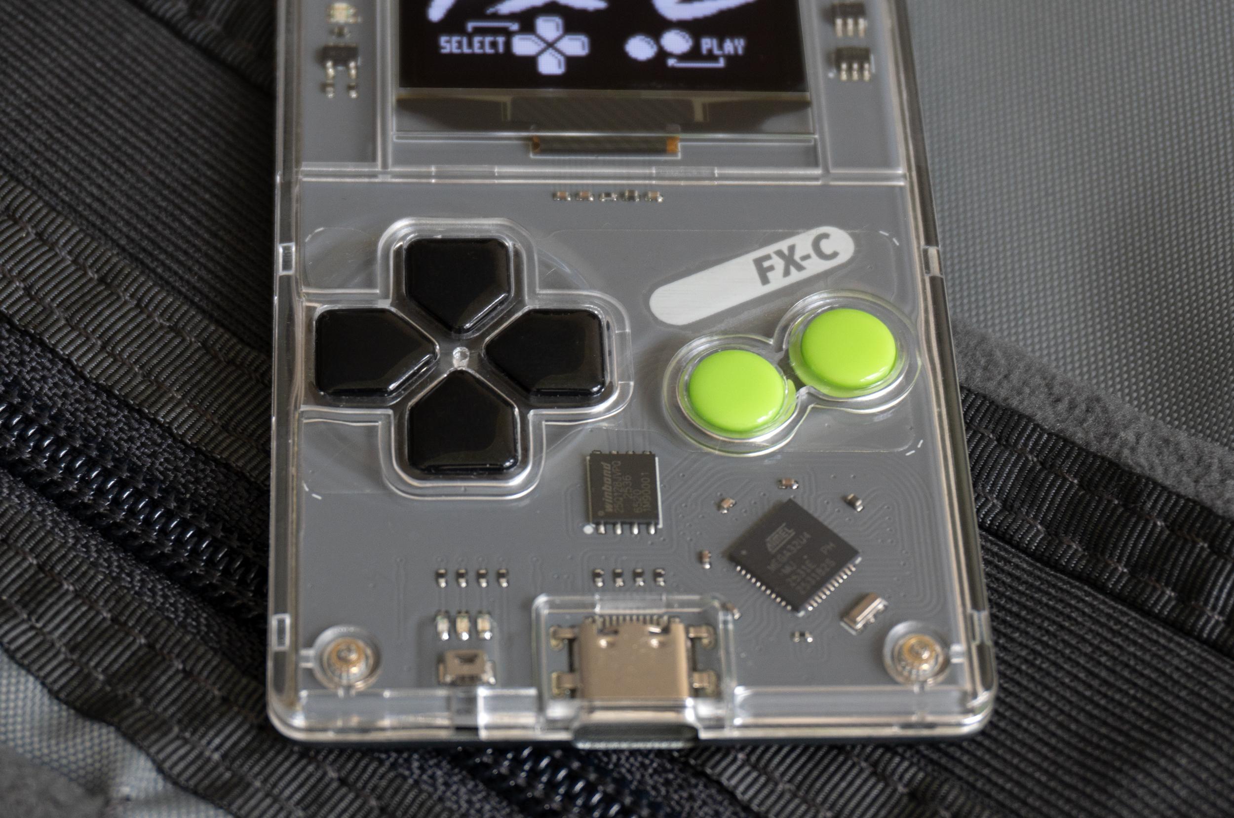 A close-up of the Arduboy FX-C’s buttons. A close-up of the Arduboy FX-C’s buttons.