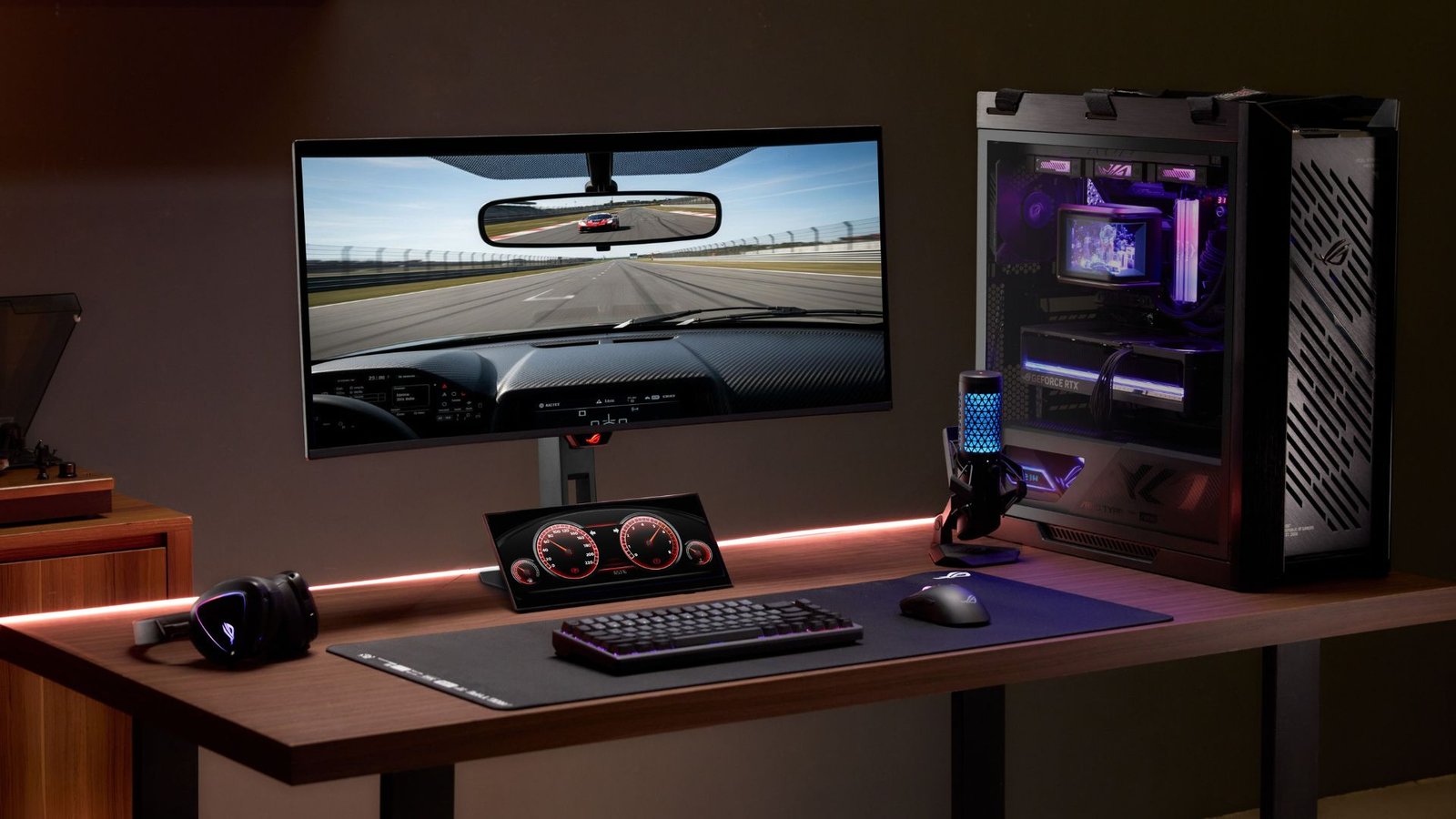 A gaming PC on a desk with an Asus ROG monitor and an ROG Strix XG129C secondary display
