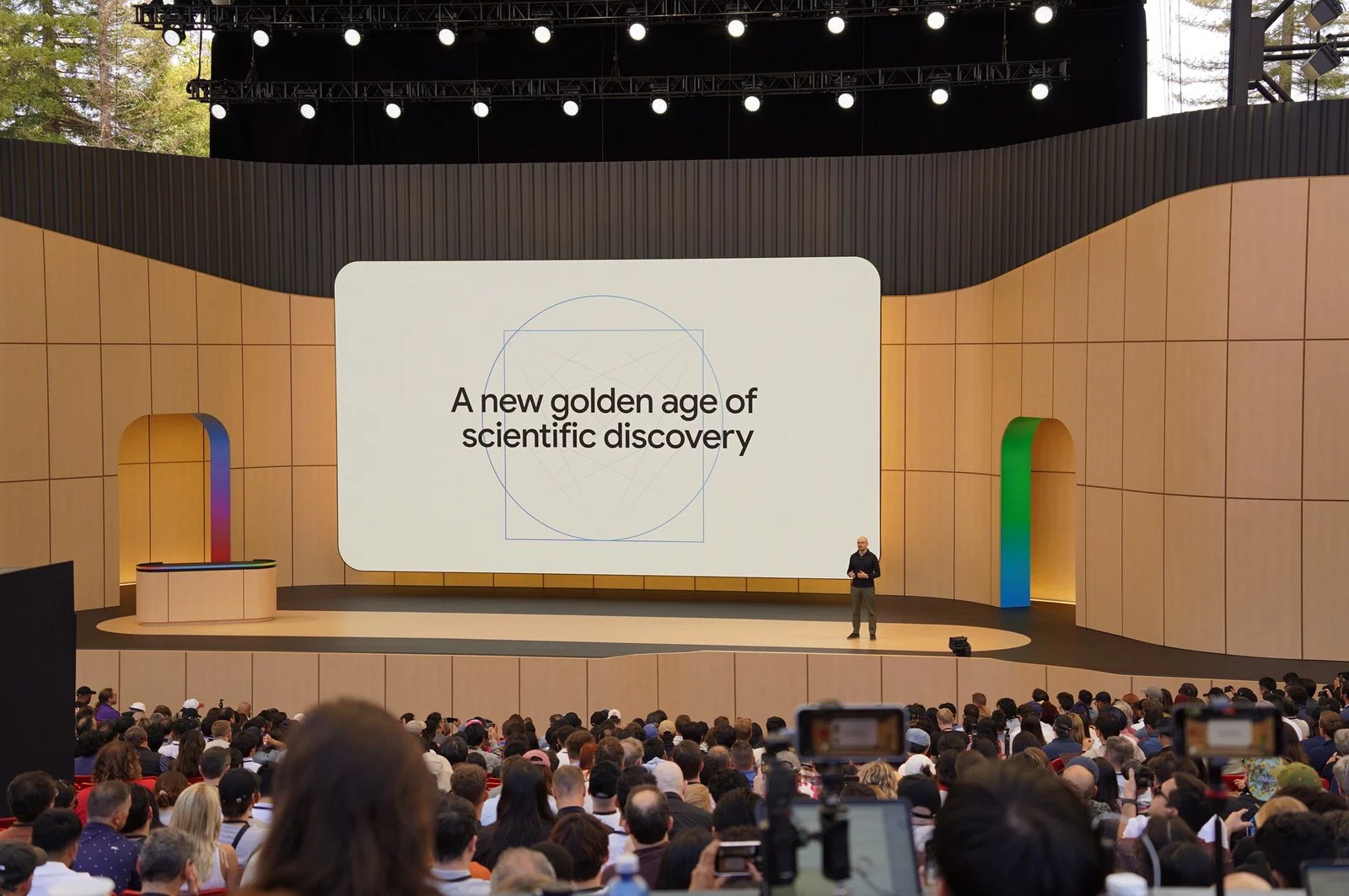 A picture of Demis Hassabis onstage at Google I/O 2026 with the screen behind him saying “A new golden age of scientific discovery”