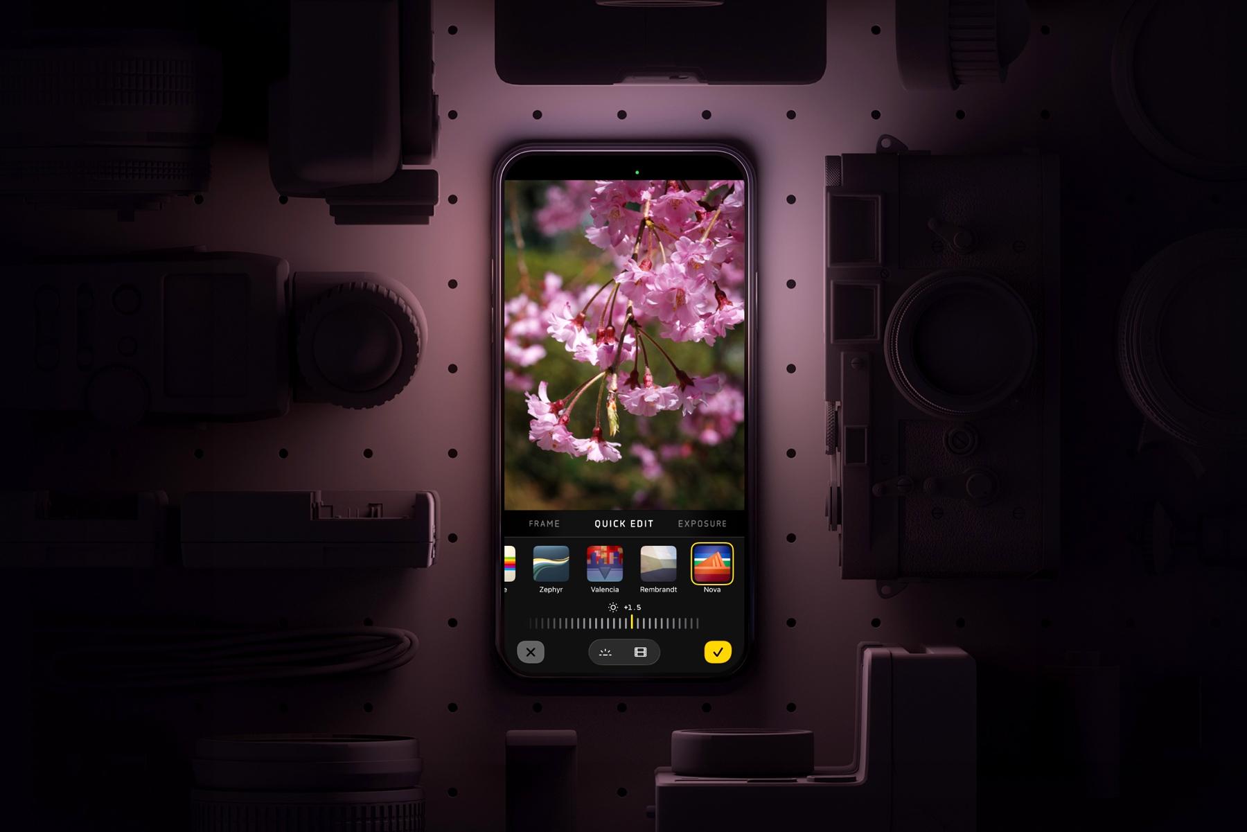 An iPhone running the Lux Optics Halide Mark III camera app surrounded by other camera gear.