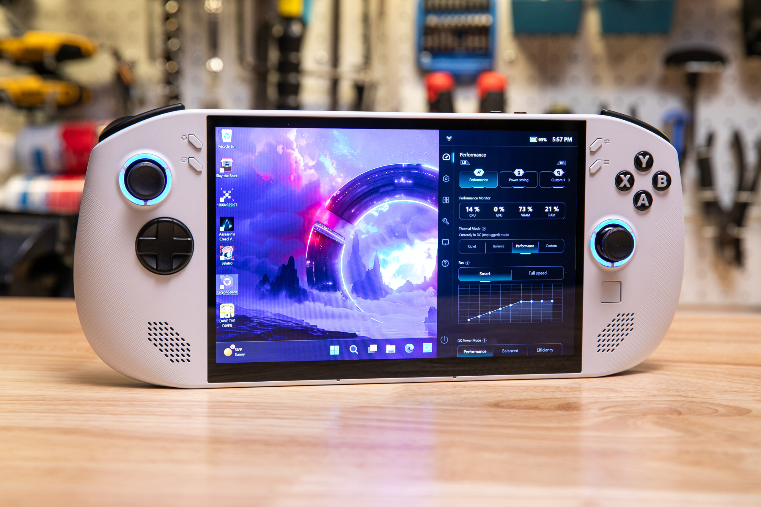 A white handheld gaming PC with joysticks, face buttons, and Windows on the screen.