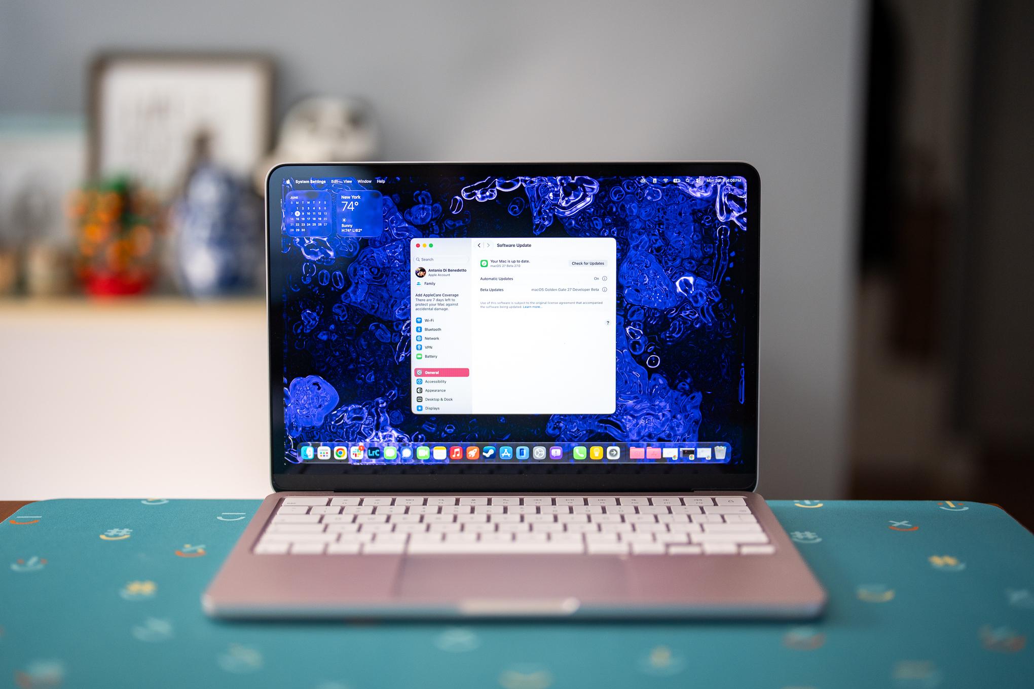 A MacBook Neo sitting on a table with the Settings open showing that it’s running macOS 27 Golden Gate Developer Beta.