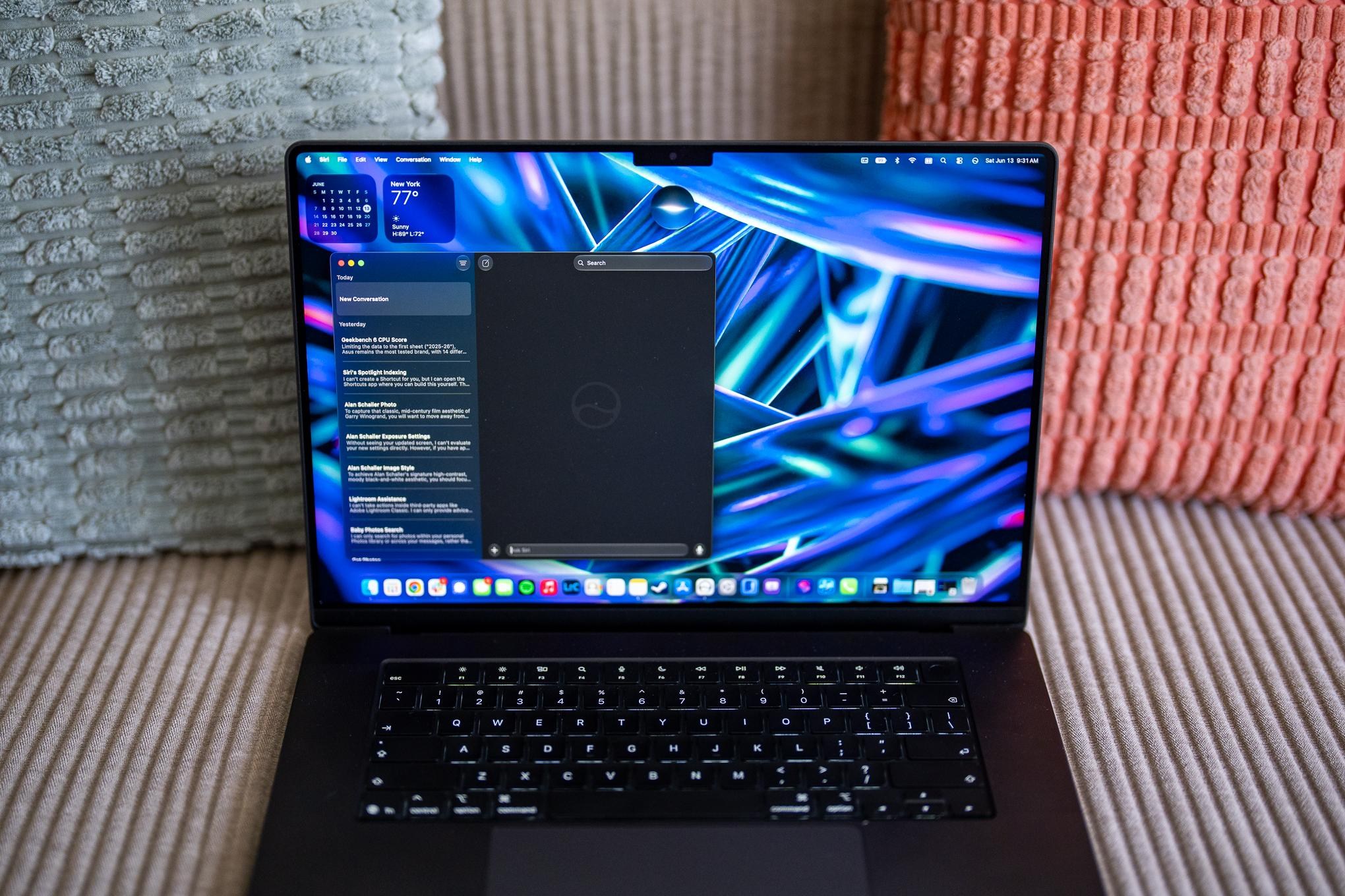 A MacBook Pro resting on a couch with Siri AI running on the macOS 27 Golden Gate developer beta.