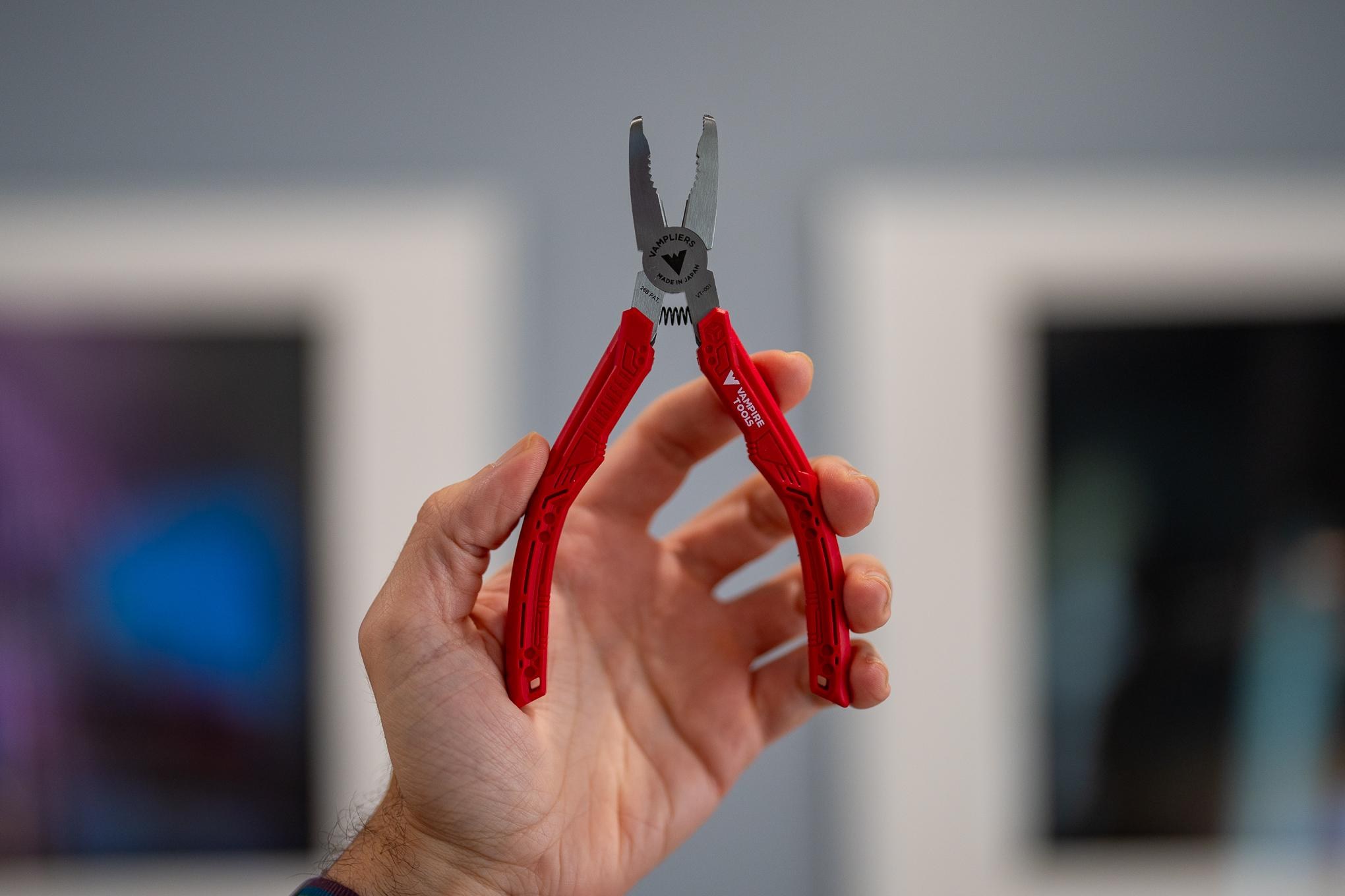 A person’s hand holding a pair of Vampliers stripped screw extractor pliers.