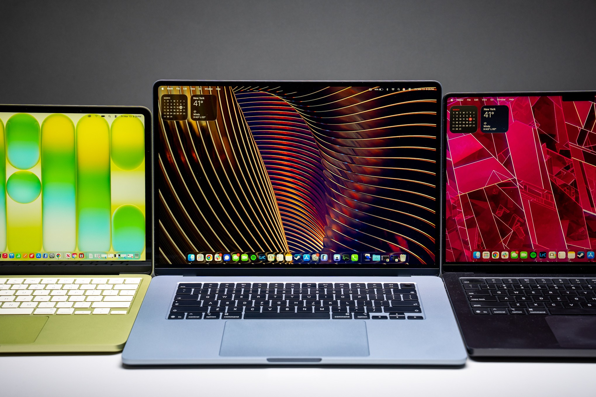 A lineup of MacBooks. The MacBook Neo (left), MacBook Air (center), and MacBook Pro (right).