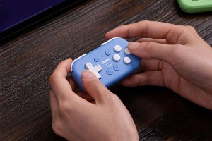 8BitDo’s Micro Bluetooth Controller being held by a person.