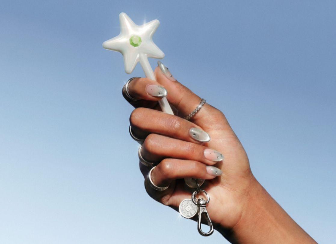 The Cash App Wand, being held by someone wearing glittery nail polish.