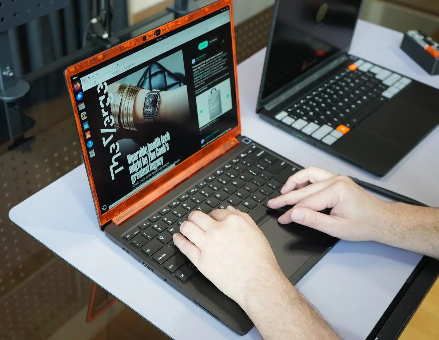 A person using a Framework Laptop 13 Pro on a workbench.