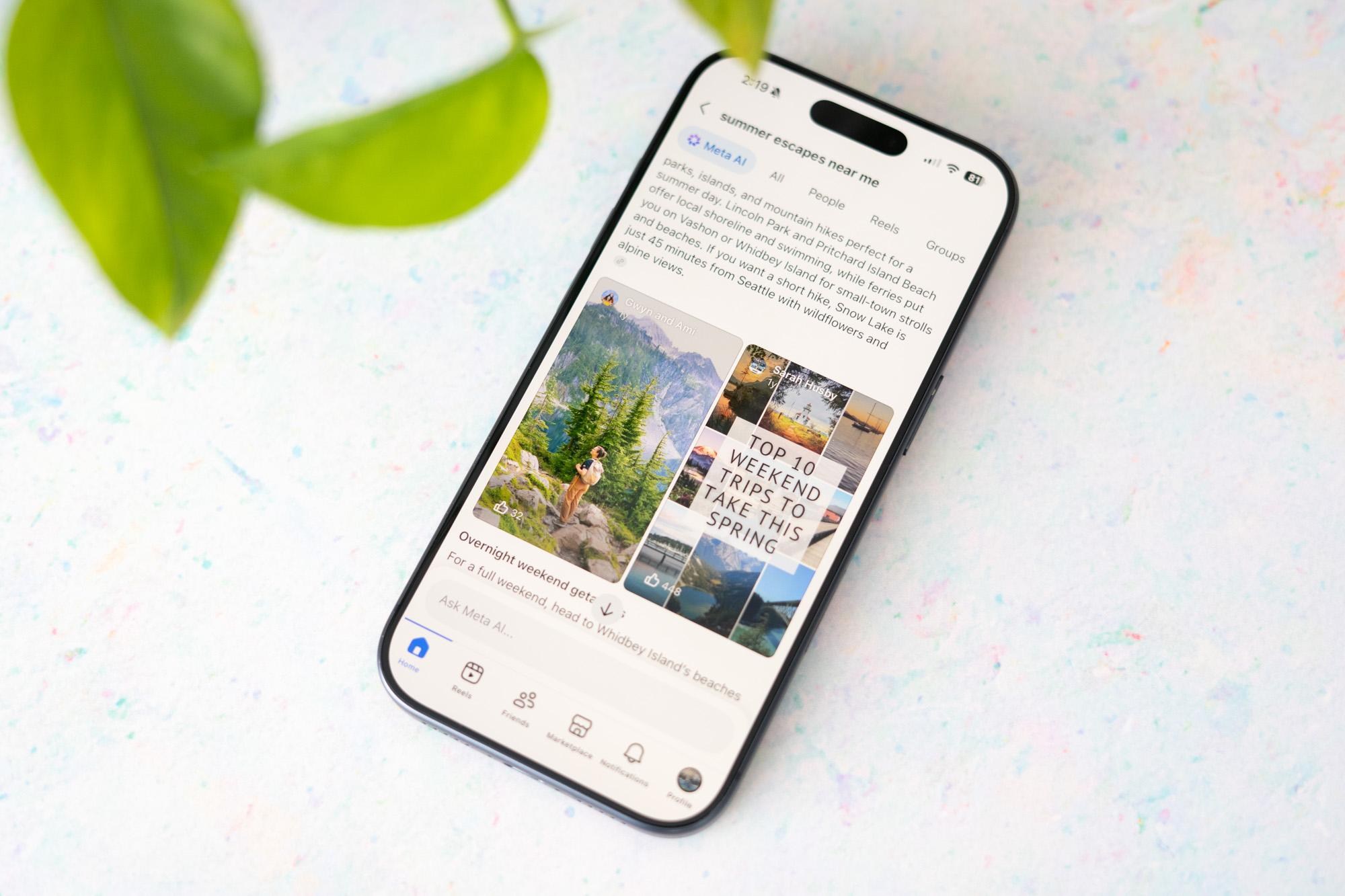 An iPhone with the Facebook app on screen showing Meta AI Mode search