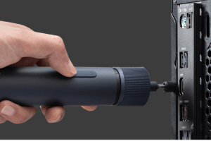 Someone using the Hoto 3.6V electric screwdriver to work on a computer.