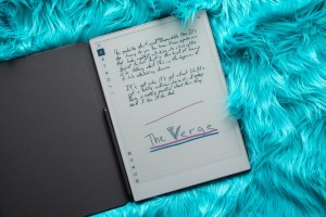 An image of the tablet in its case, lying open on a turquoise fur.