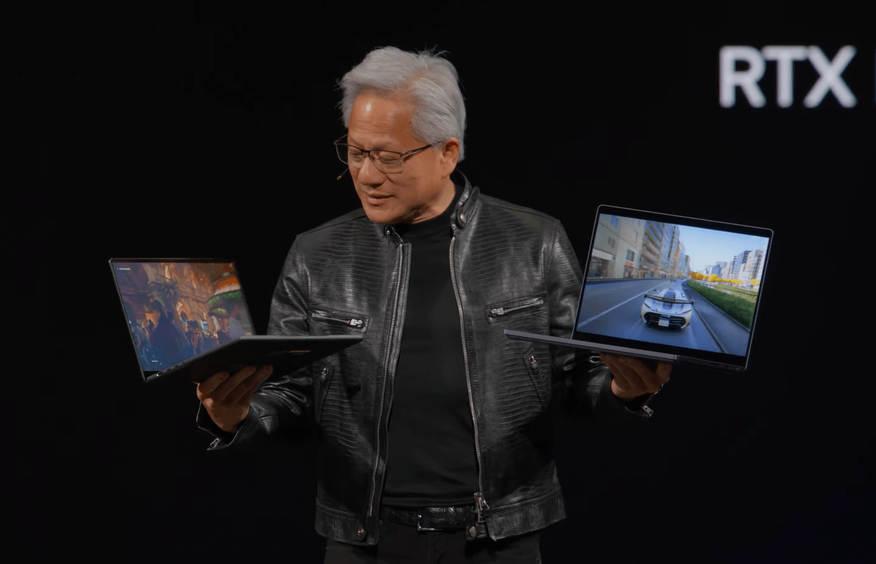 Nvidia CEO Jensen Huang holds up two RTX Spark laptops at Computex 2026