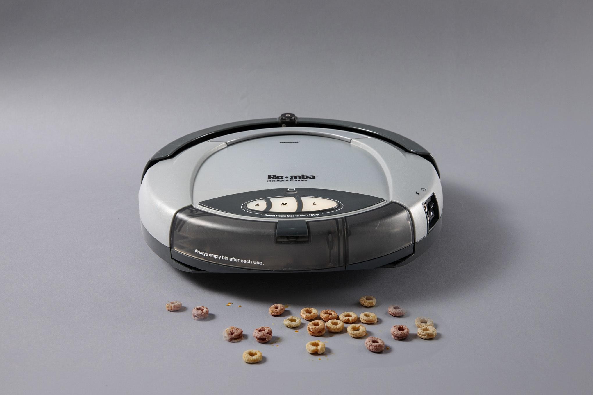 A photo of a robot vacuum sucking up cereal.